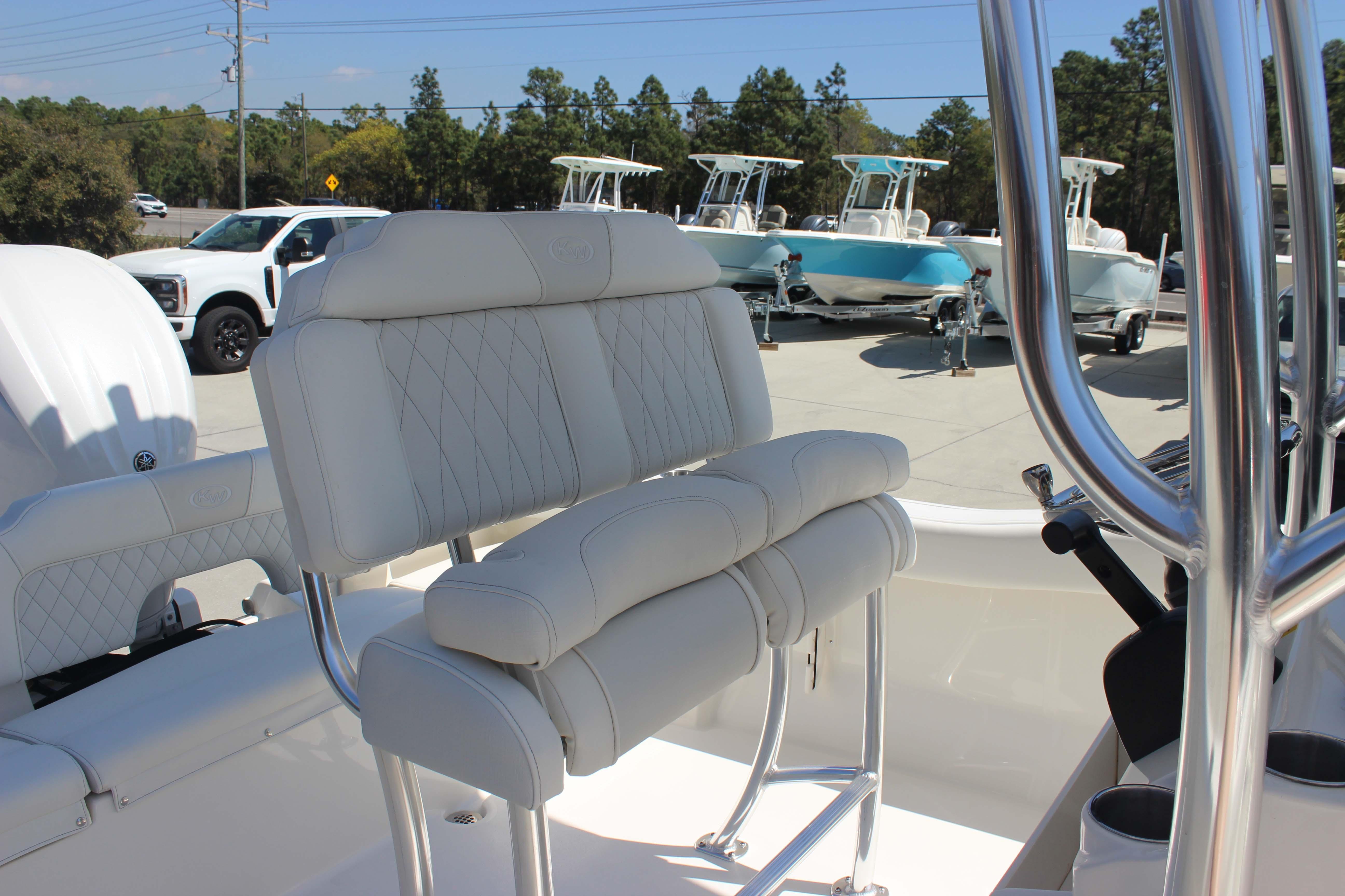 2026 Key West 203 FS boat interior with white cushioned seating and chrome details.