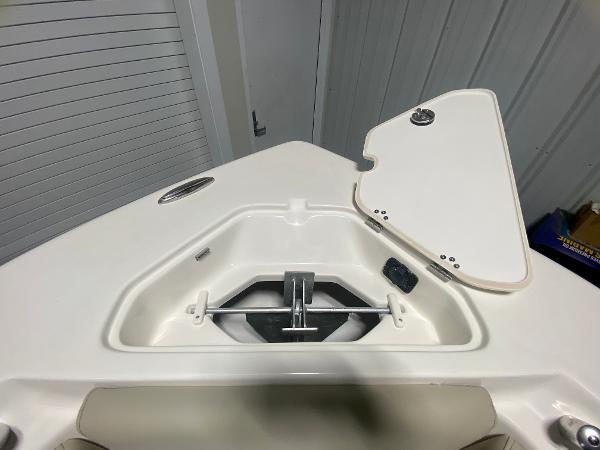 2024 Key West 219 FS boat anchor storage compartment with open hatch.
