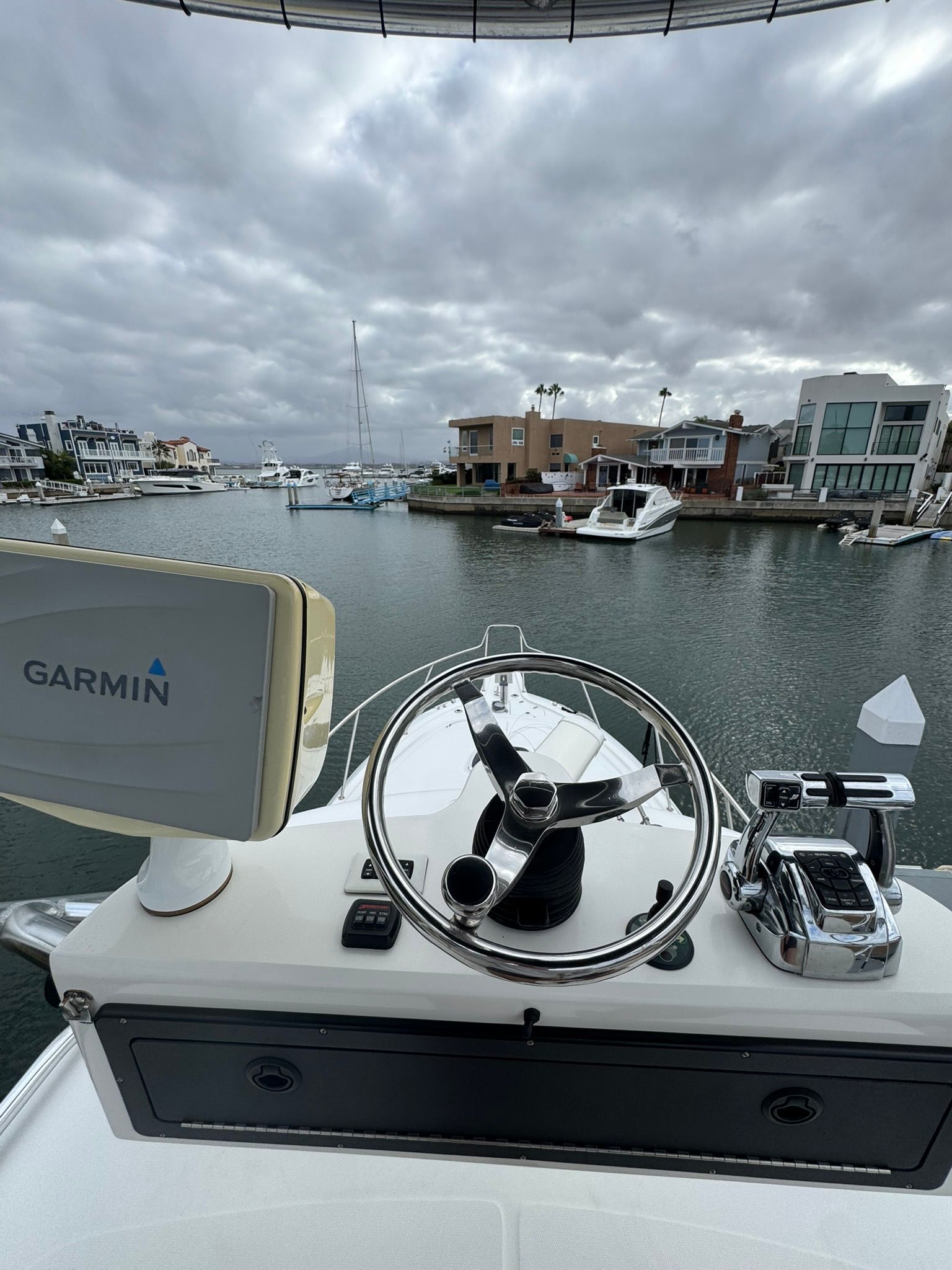 Helm of a Boston Whaler 345 Conquest overlooking a marina.