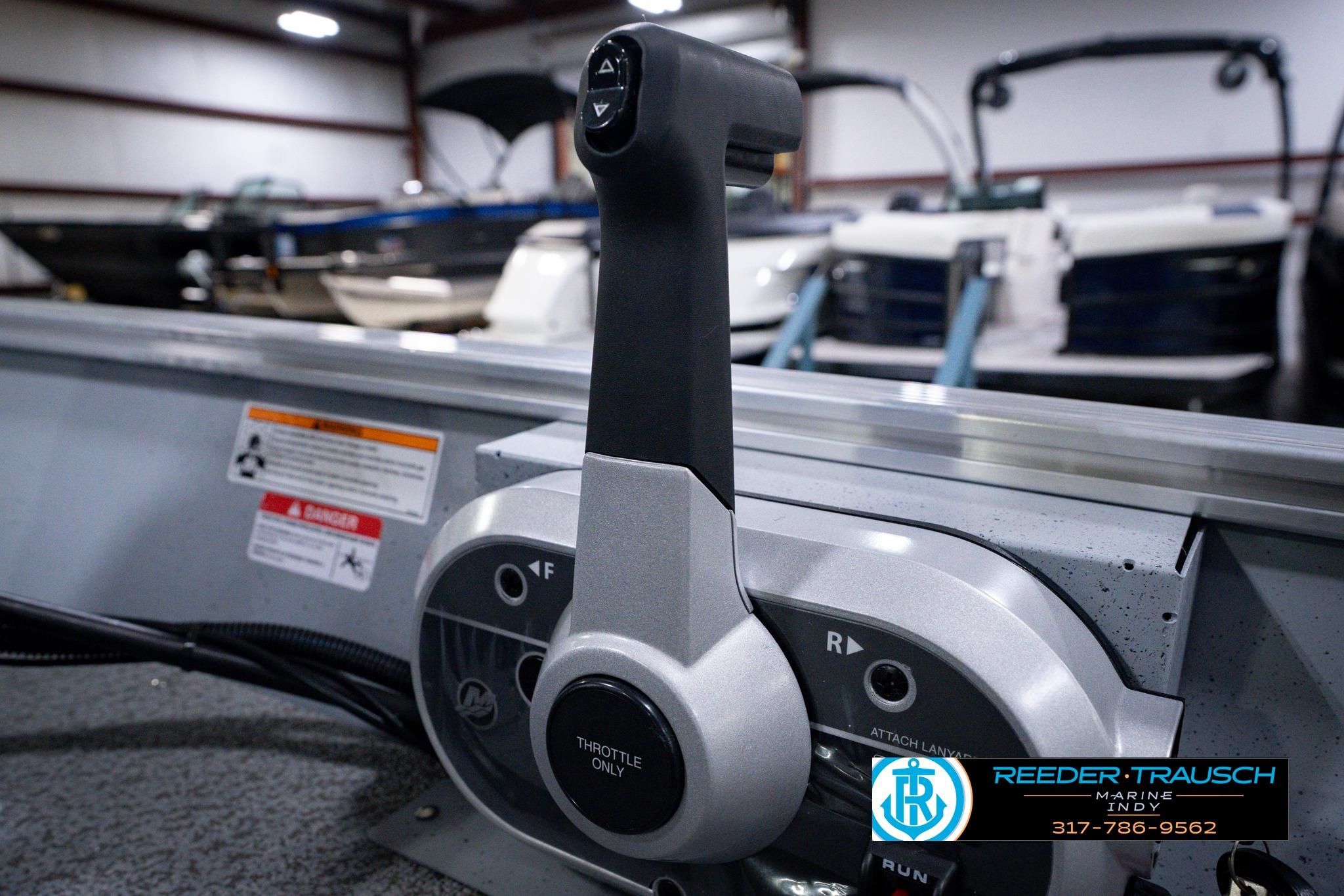 Throttle control of 2026 Lund 1600 Fury SS boat in showroom setting.