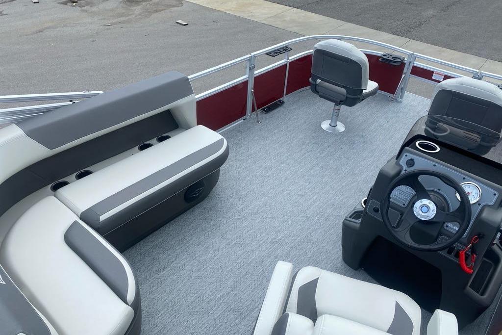 2026 Sun Tracker Bass Buggy 16 XL Select pontoon boat interior with seating and steering console.