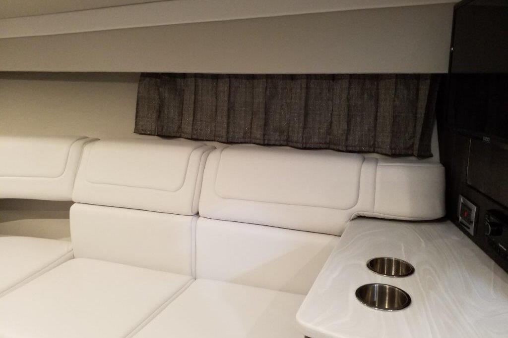 Interior of 2021 Formula 350 Sun Sport with white seating and cup holders.