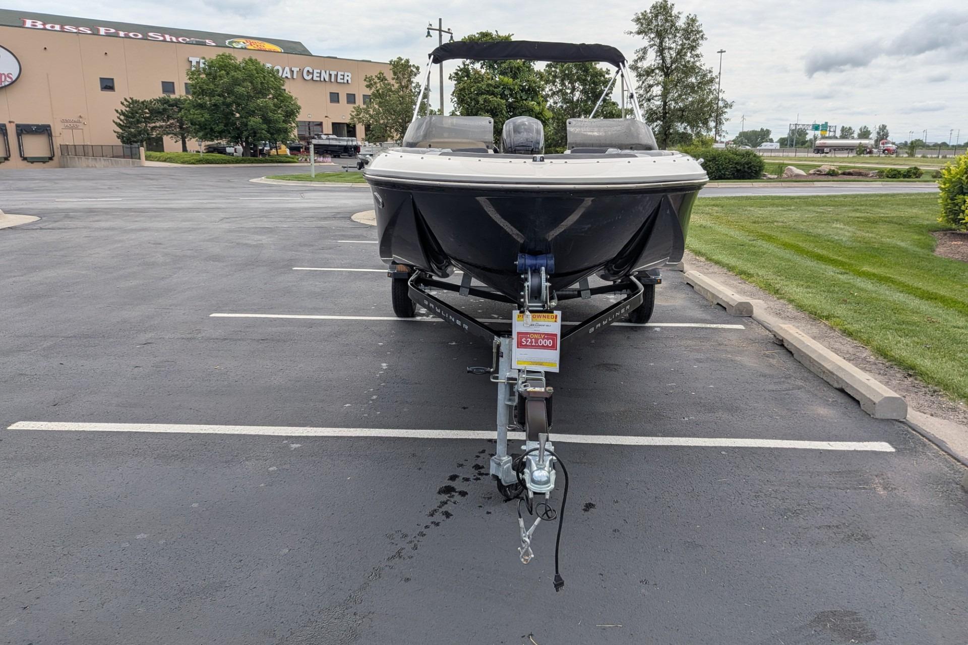 2023 Bayliner Element M17 boat on trailer, parked in lot near Bass Pro Shops.