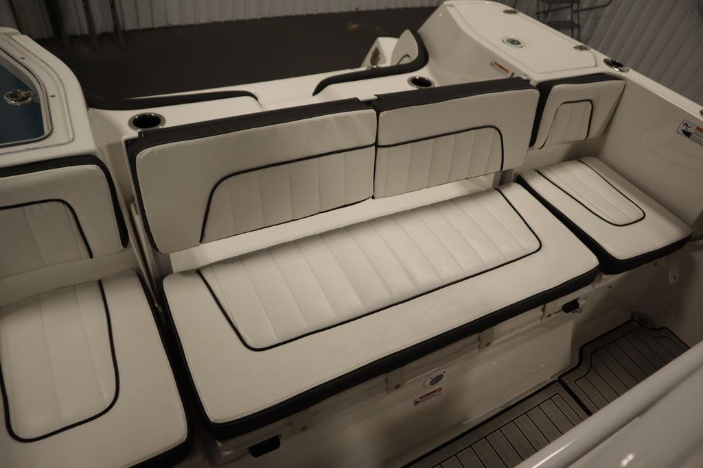 2026 Yamaha Boats 255 FSH Sport E interior seating with white cushioned seats.