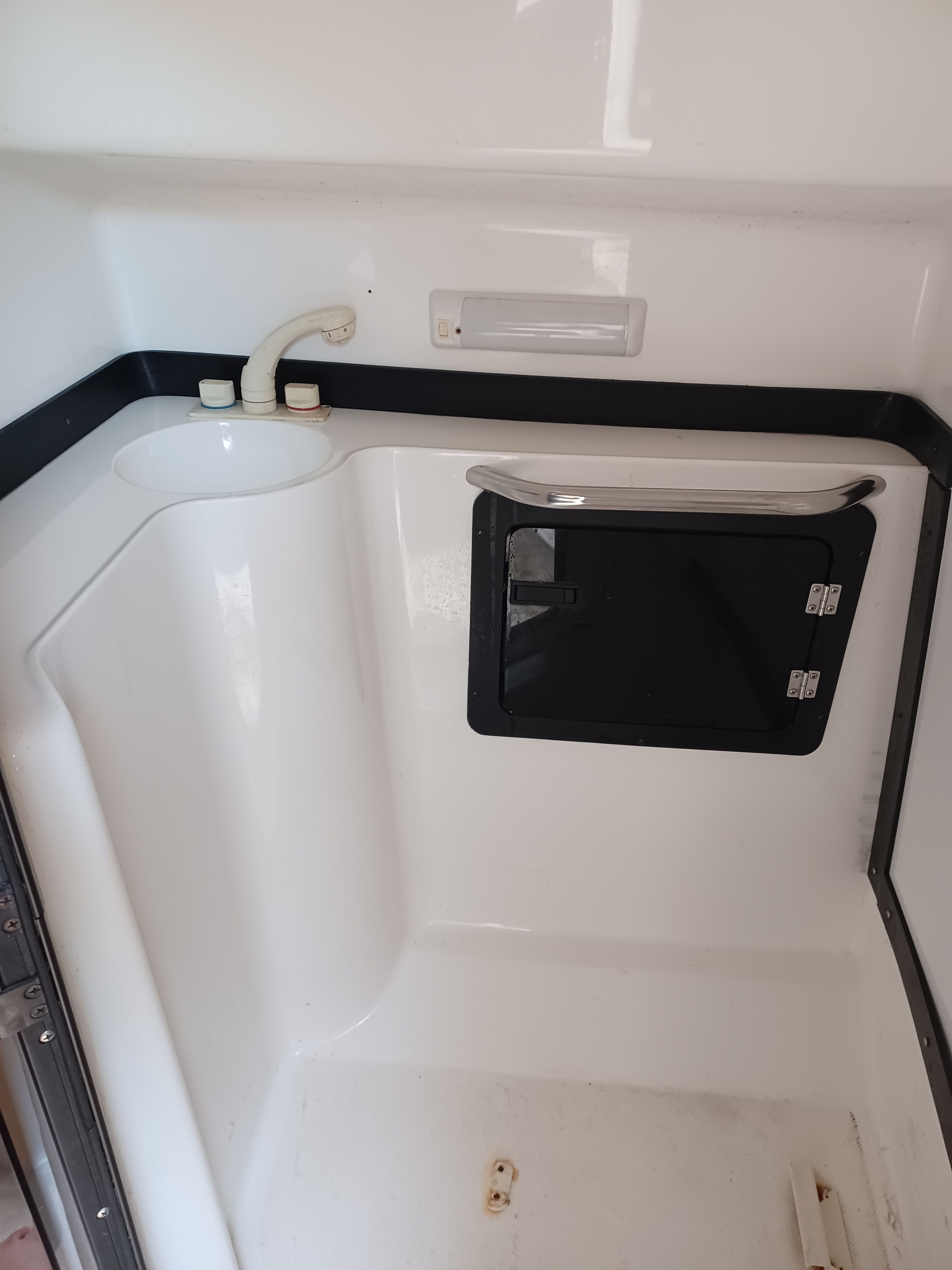 Interior of a 1995 Fountain 31 SFC with a sink and storage area.