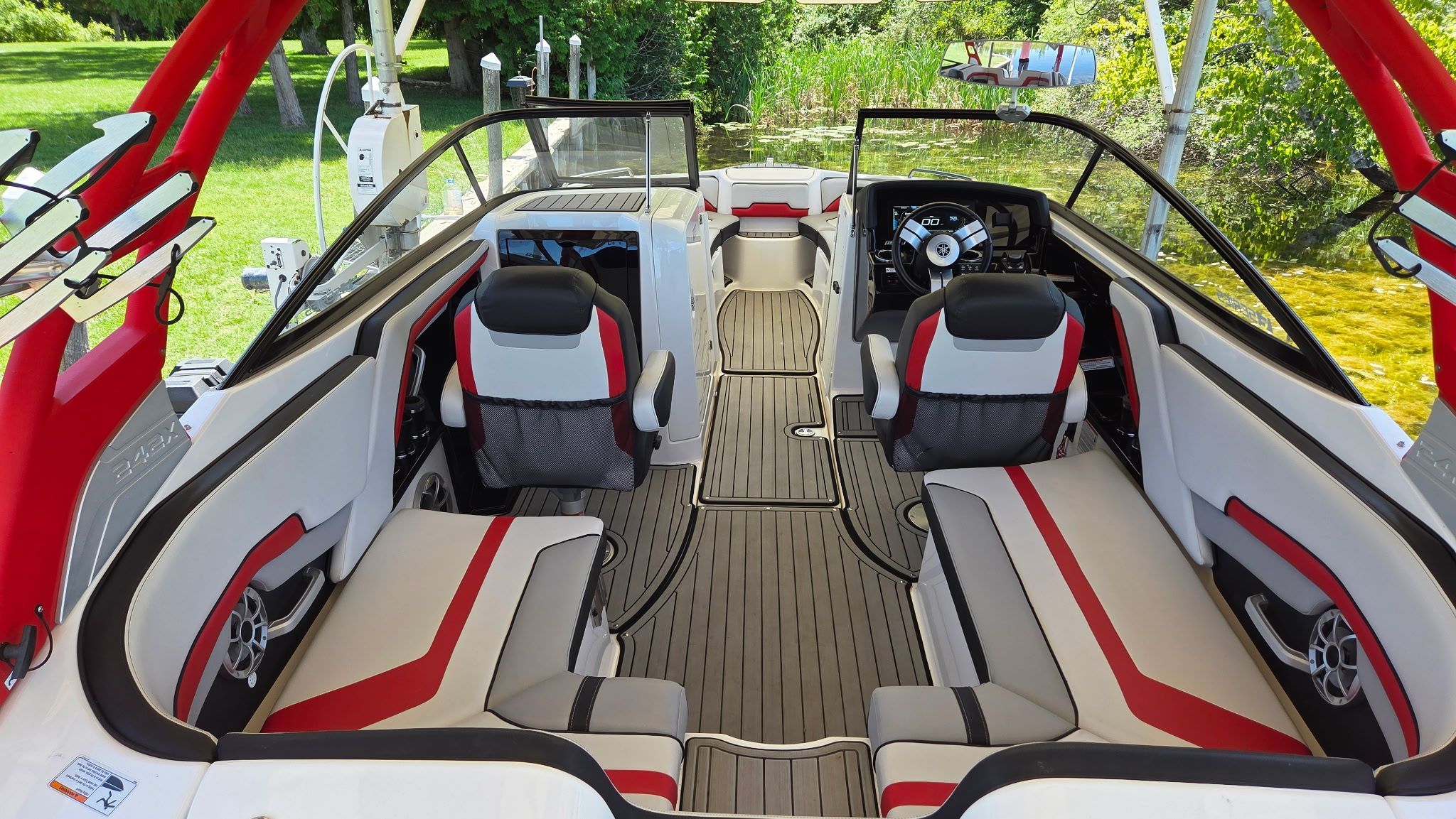 Interior view of a 2018 Yamaha 242X E-Series boat with modern seating and helm.