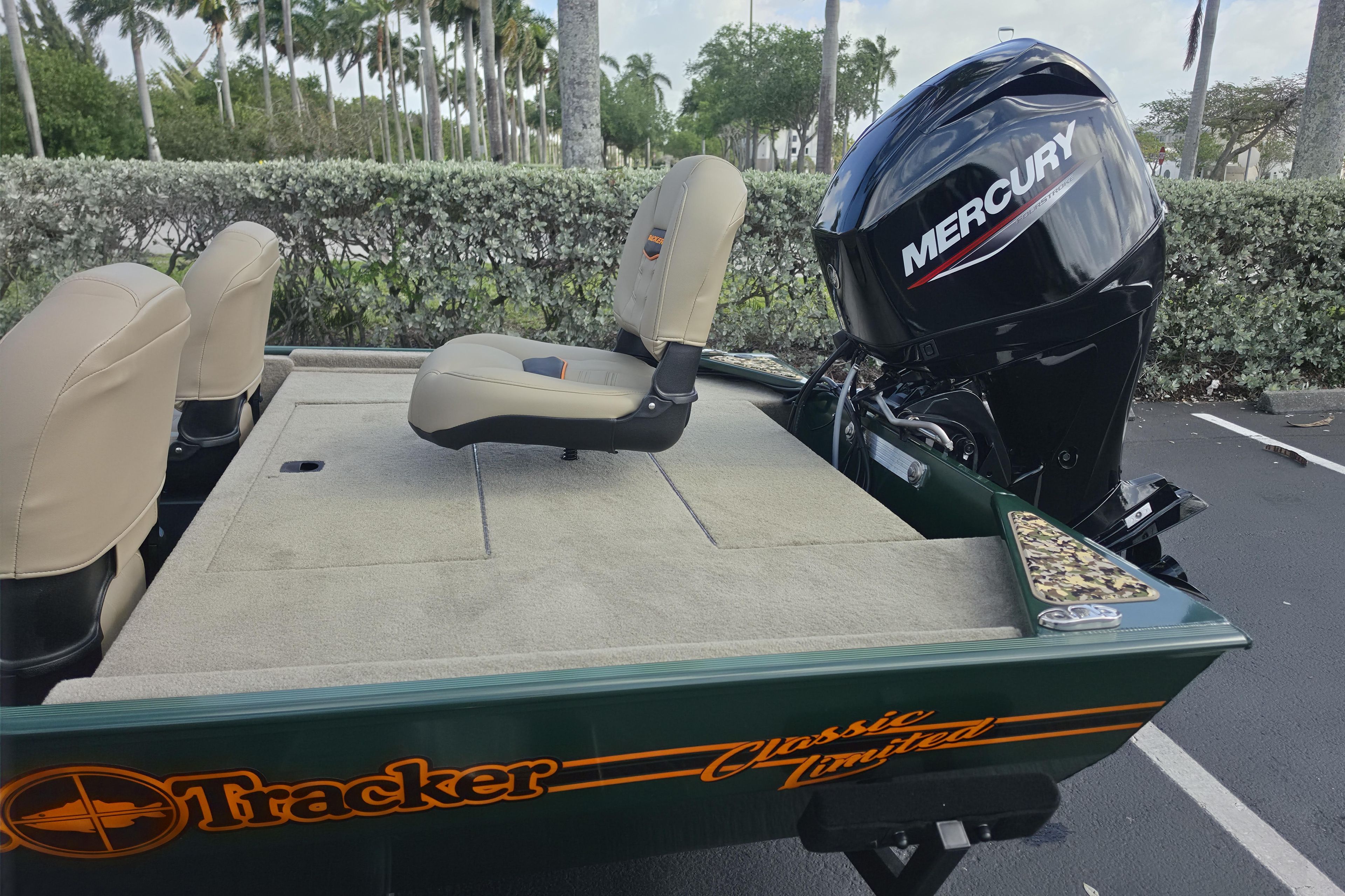 2026 Tracker Bass Tracker Classic Limited boat with Mercury engine, beige seats, and green exterior.