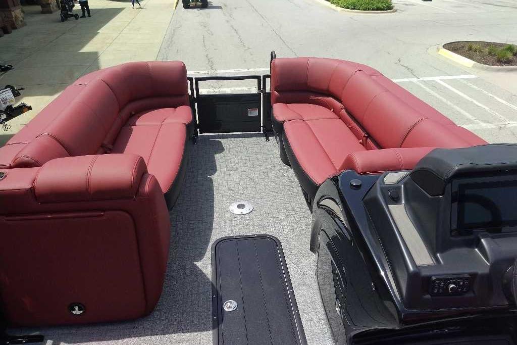 2026 Regency 230 DL pontoon boat with red seating and spacious deck layout.