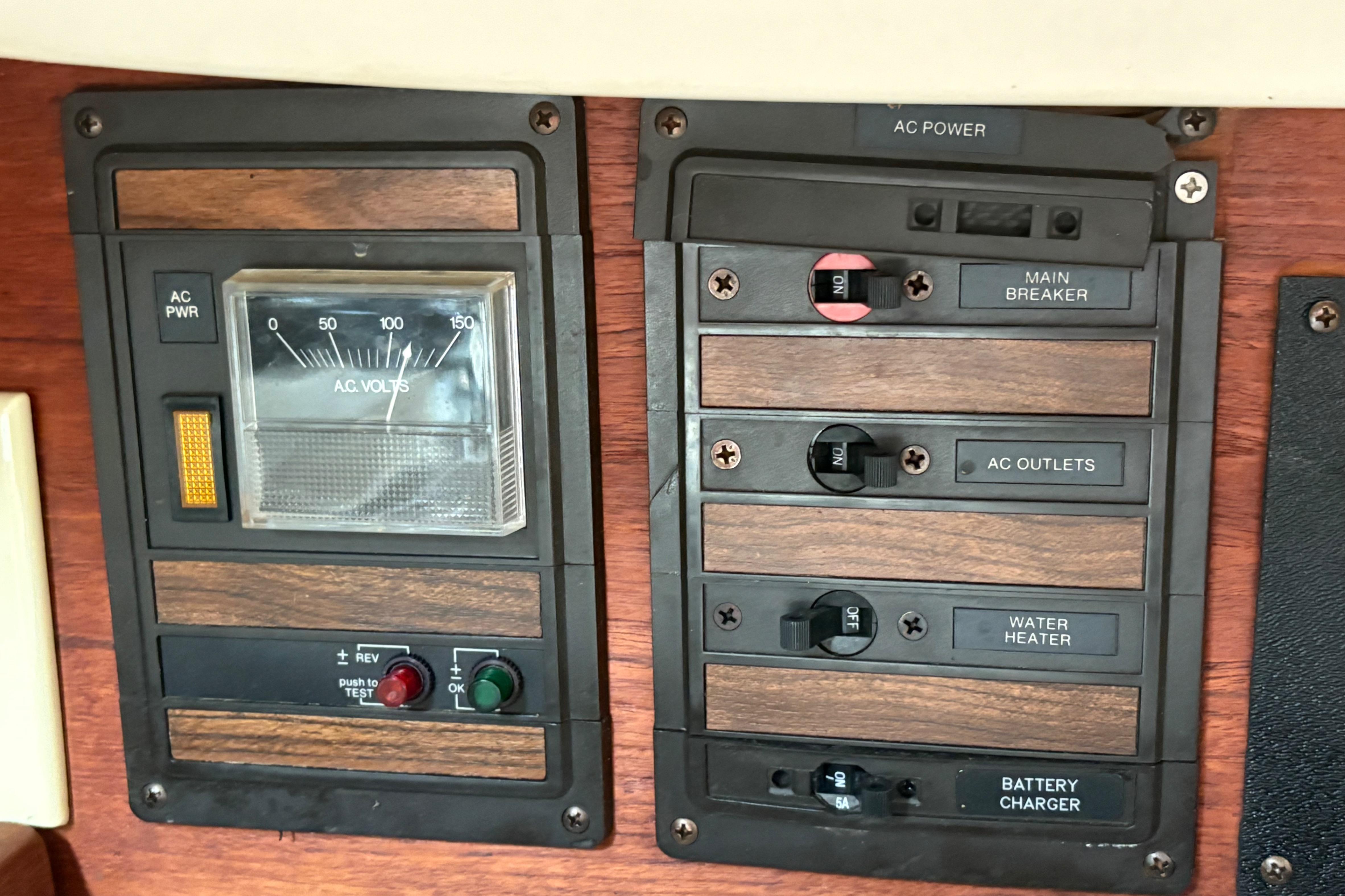 Electrical panel of a 1981 Sabre 31 sailboat with AC power controls and voltmeter.