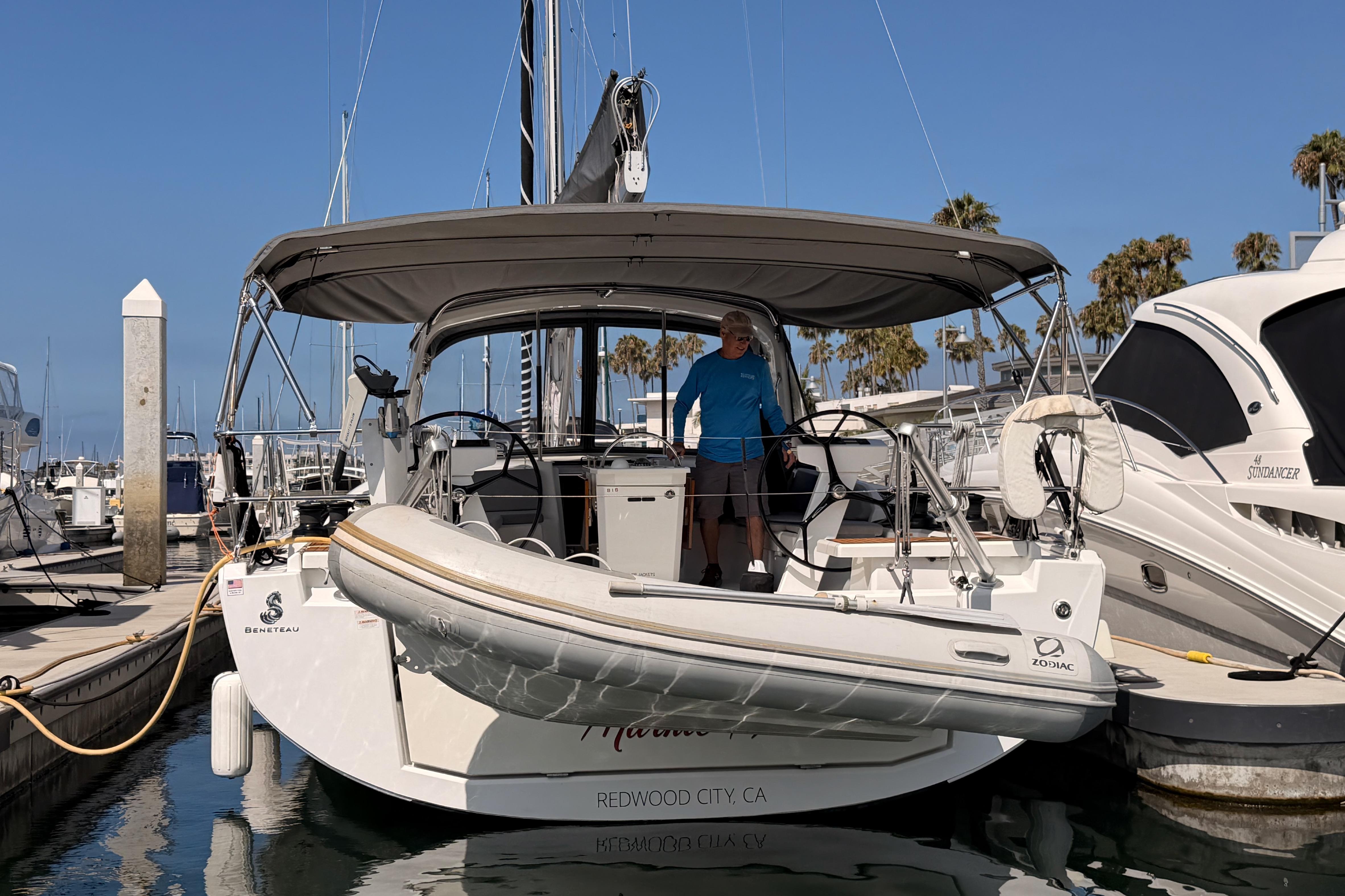 2020 Beneteau Oceanis 46.1 yacht docked at marina with inflatable boat attached.
