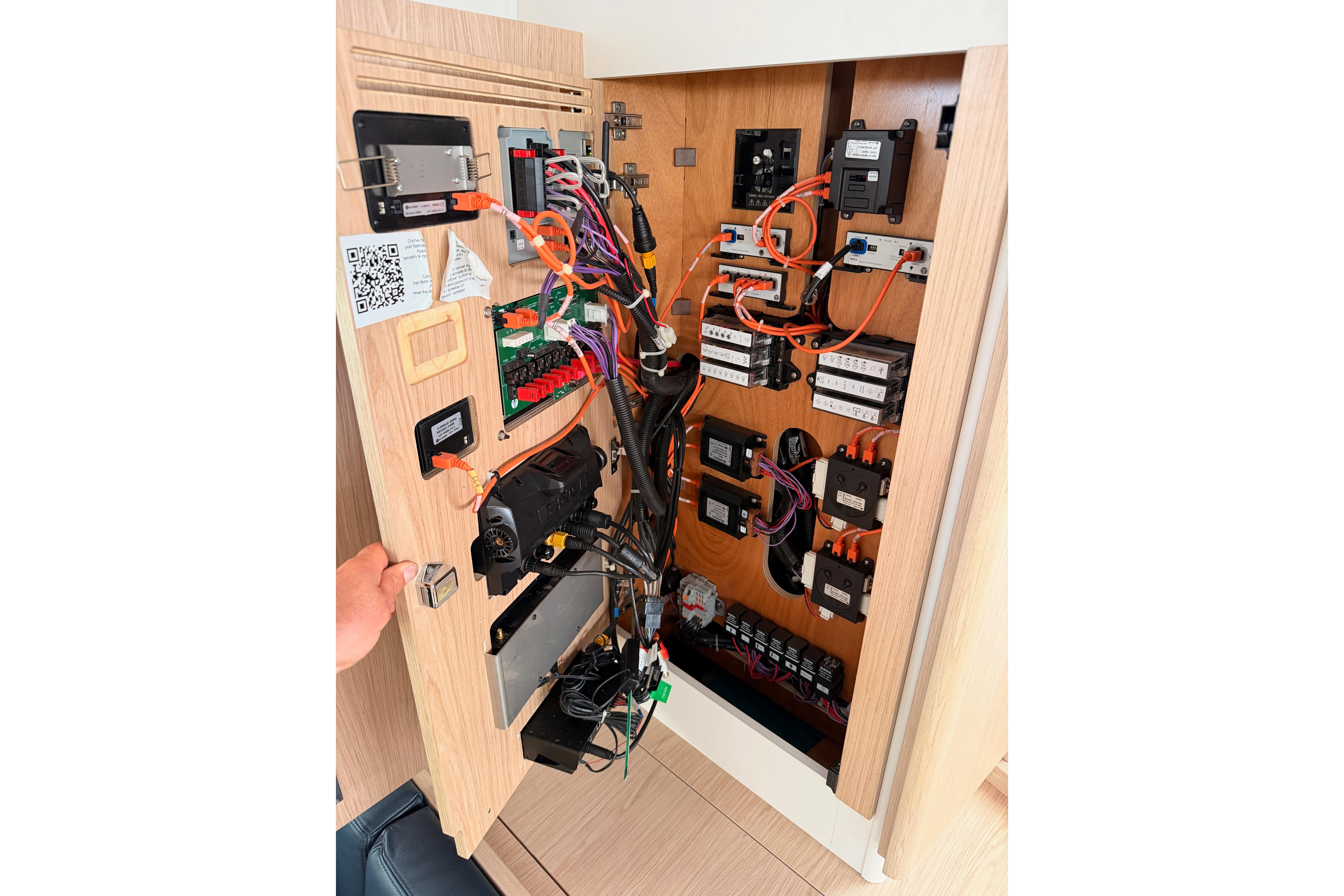 Electrical panel inside 2022 Beneteau Oceanis Yacht 54, showcasing wiring and components.
