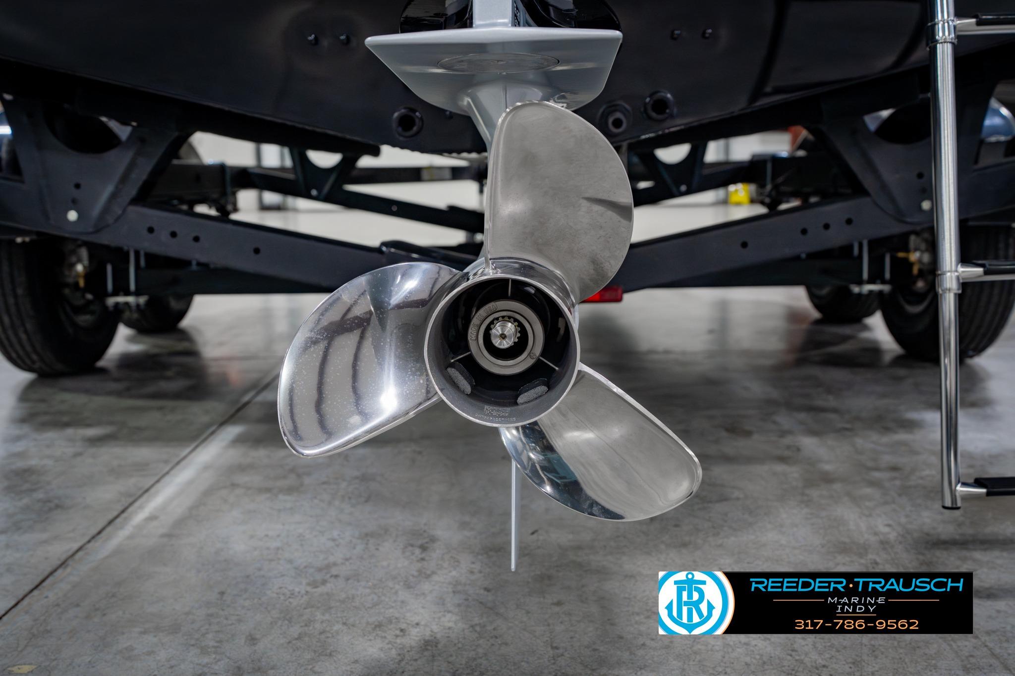 2026 Lund 1875 Impact XS boat propeller in a showroom, showcasing sleek design and engineering.