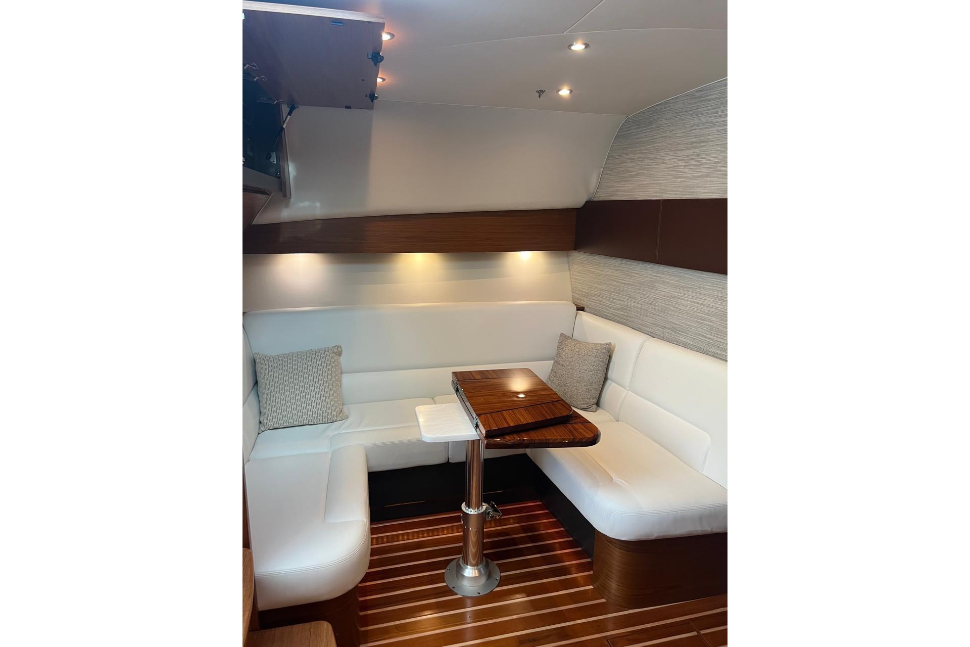 Luxurious interior of 2020 Tiara Yachts 43 Open with elegant seating and wooden table.