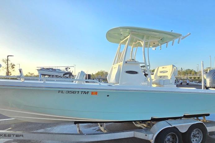 2023 Pathfinder 2600 TRS boat on trailer, side view, sunny day.