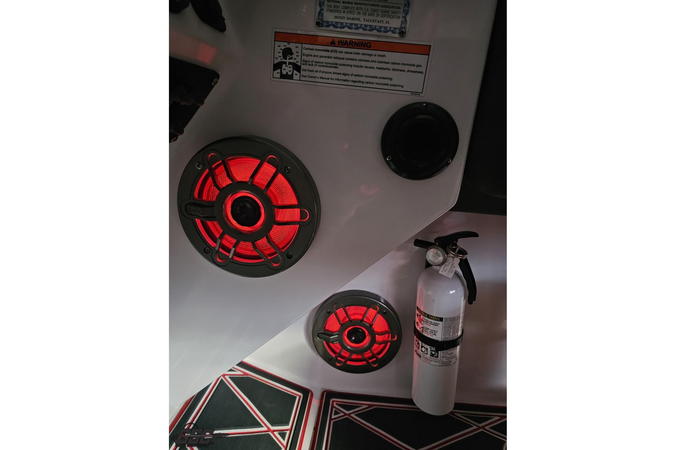 2008 Donzi 38 ZR interior with red-lit speakers and a fire extinguisher.
