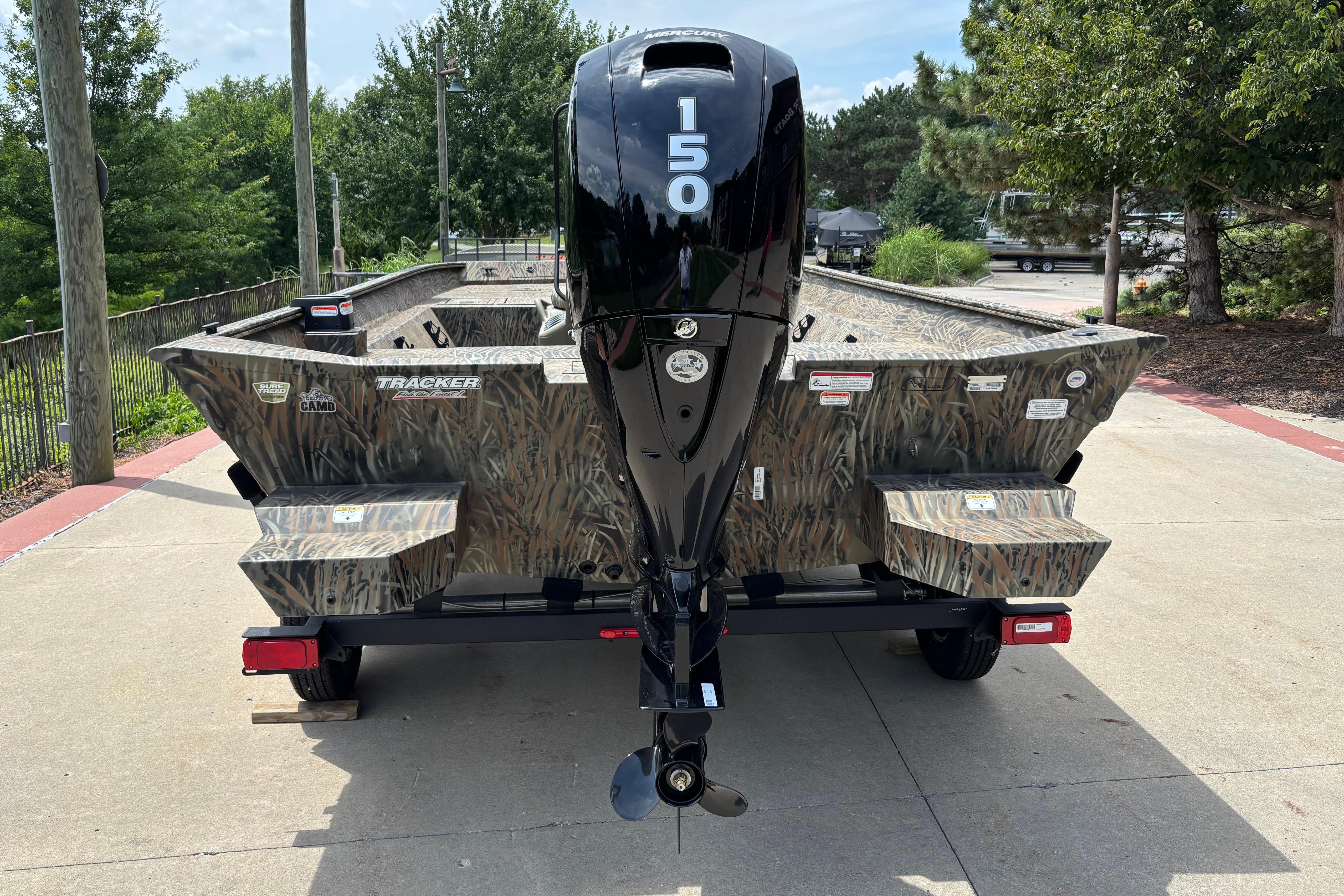 2026 Tracker Grizzly 2072 CC boat with camo design and powerful outboard motor.