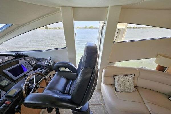 Interior view of 2005 Sunseeker Manhattan 66 yacht with helm and seating area.