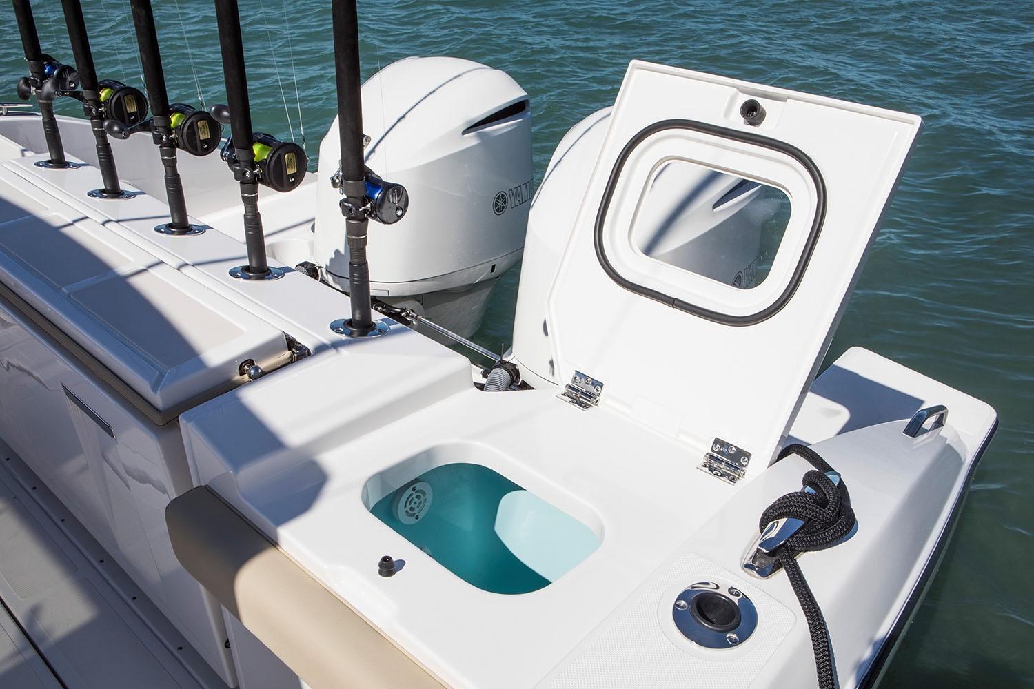 Manufacturer Provided Image: 2021 Pursuit S 328 Sport boat with open storage compartment and fishing rod holders.