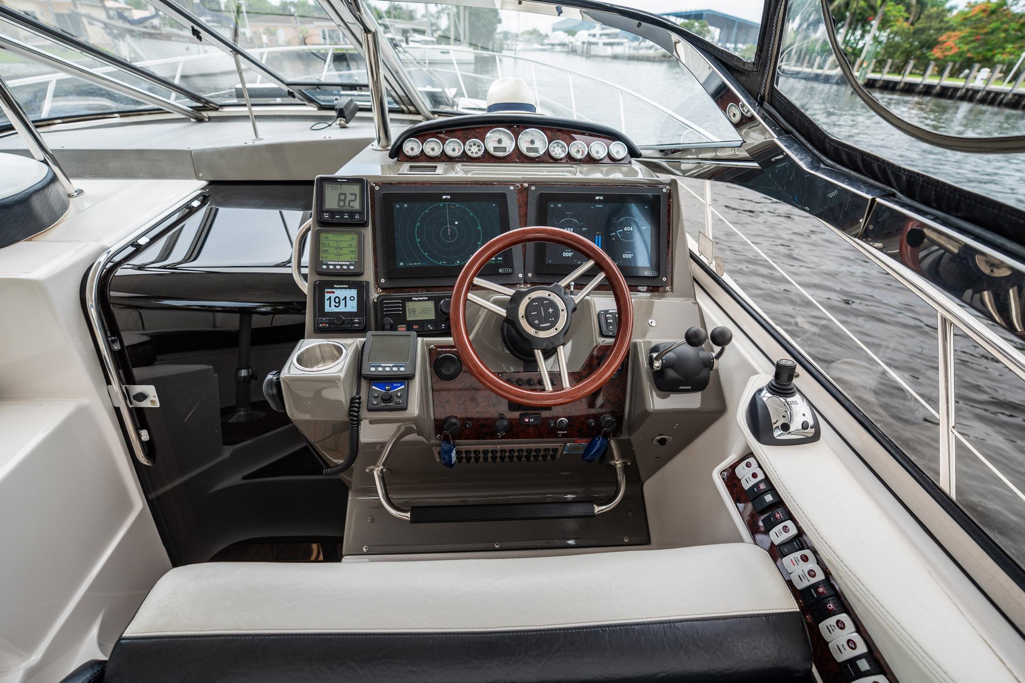 Cockpit of 2008 Regal Commodore 4460 yacht with advanced navigation controls and steering wheel.