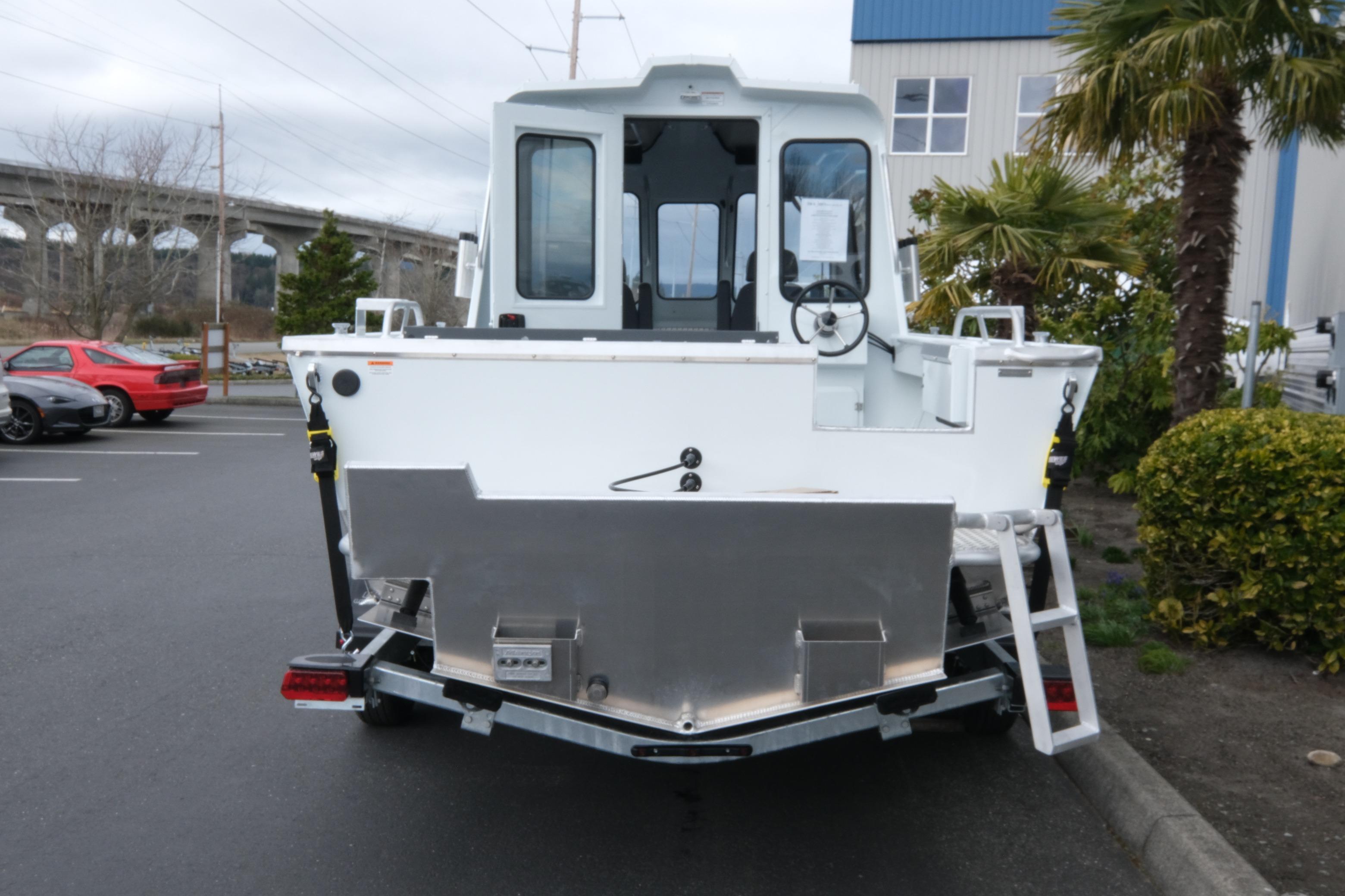 2026 Hewescraft 210 Sea Runner ET Hardtop boat, rear view in parking lot.