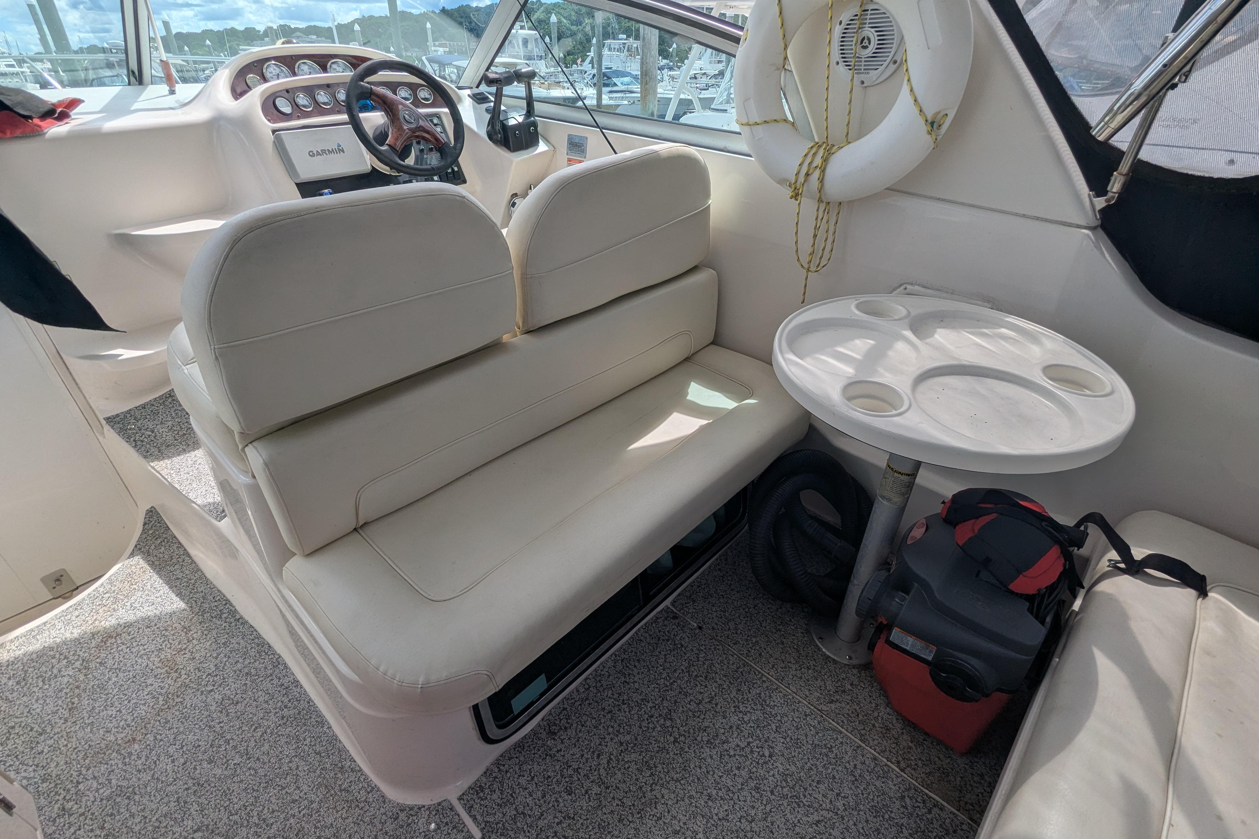 Interior of a 2003 Monterey 282 Cruiser with seating and a small table.