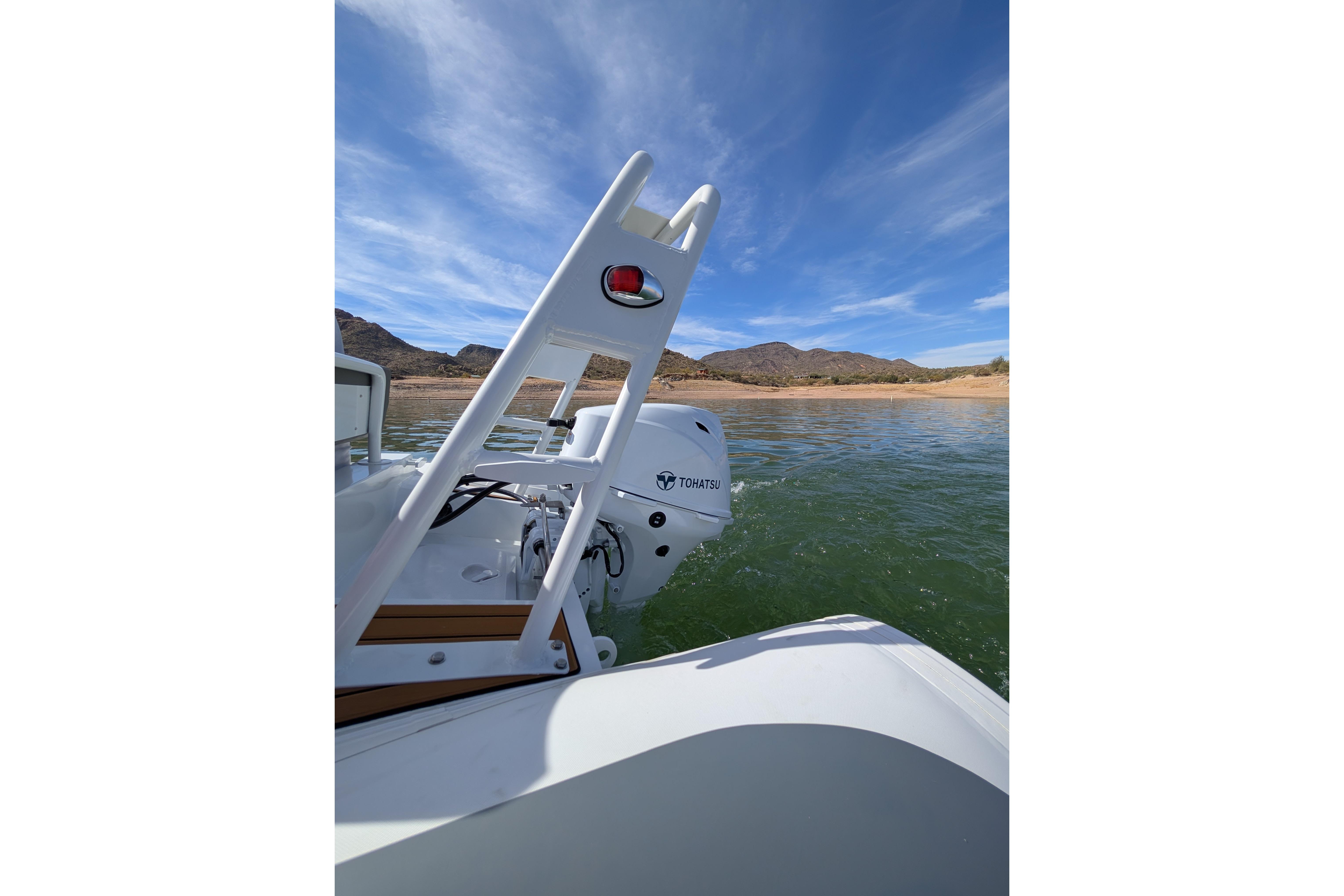 Tide Craft Beaver 10 boat on water, 2026 model, with Tohatsu motor, scenic lake view.