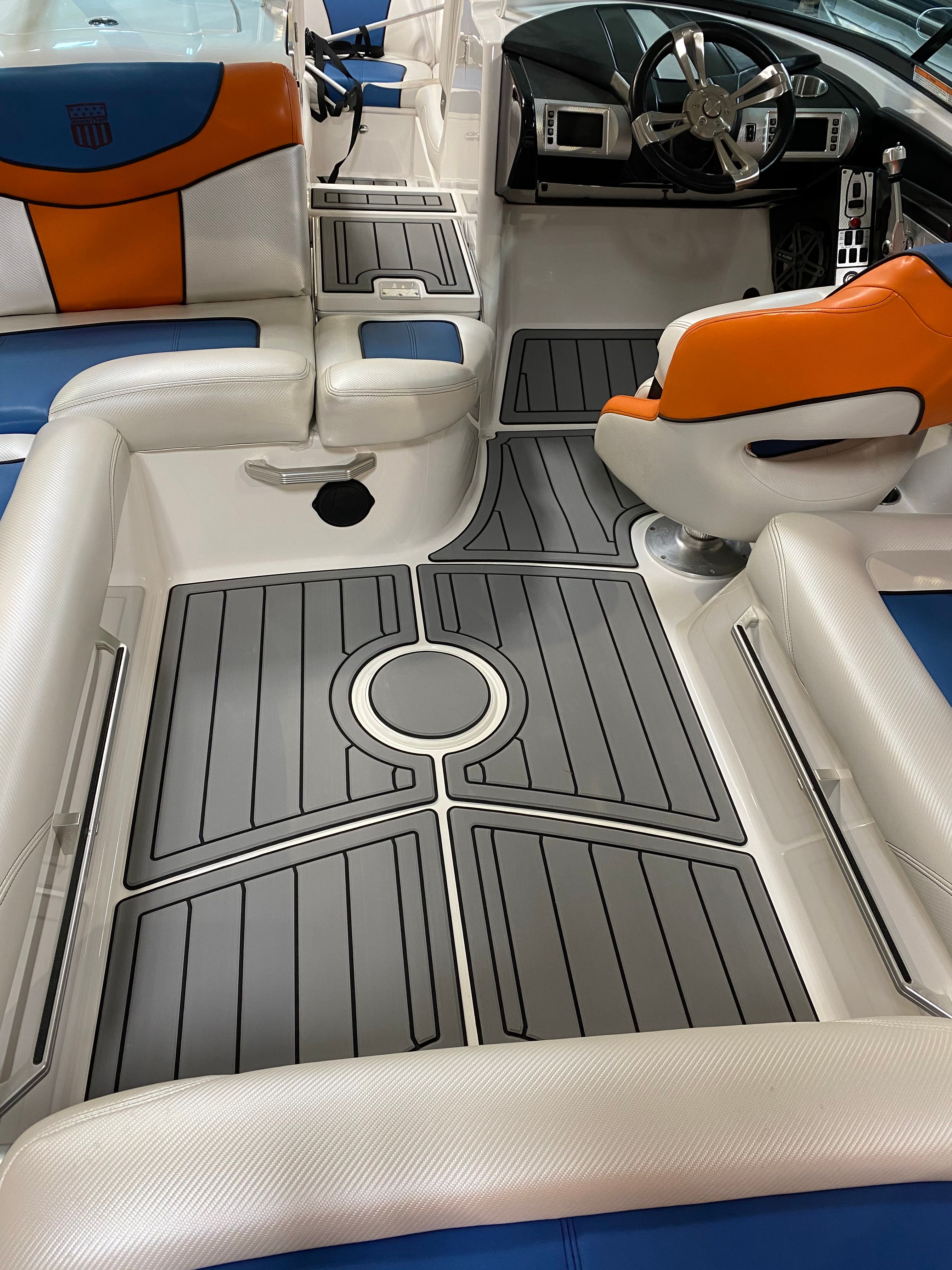 Interior of a 2013 MasterCraft XStar boat with gray flooring.