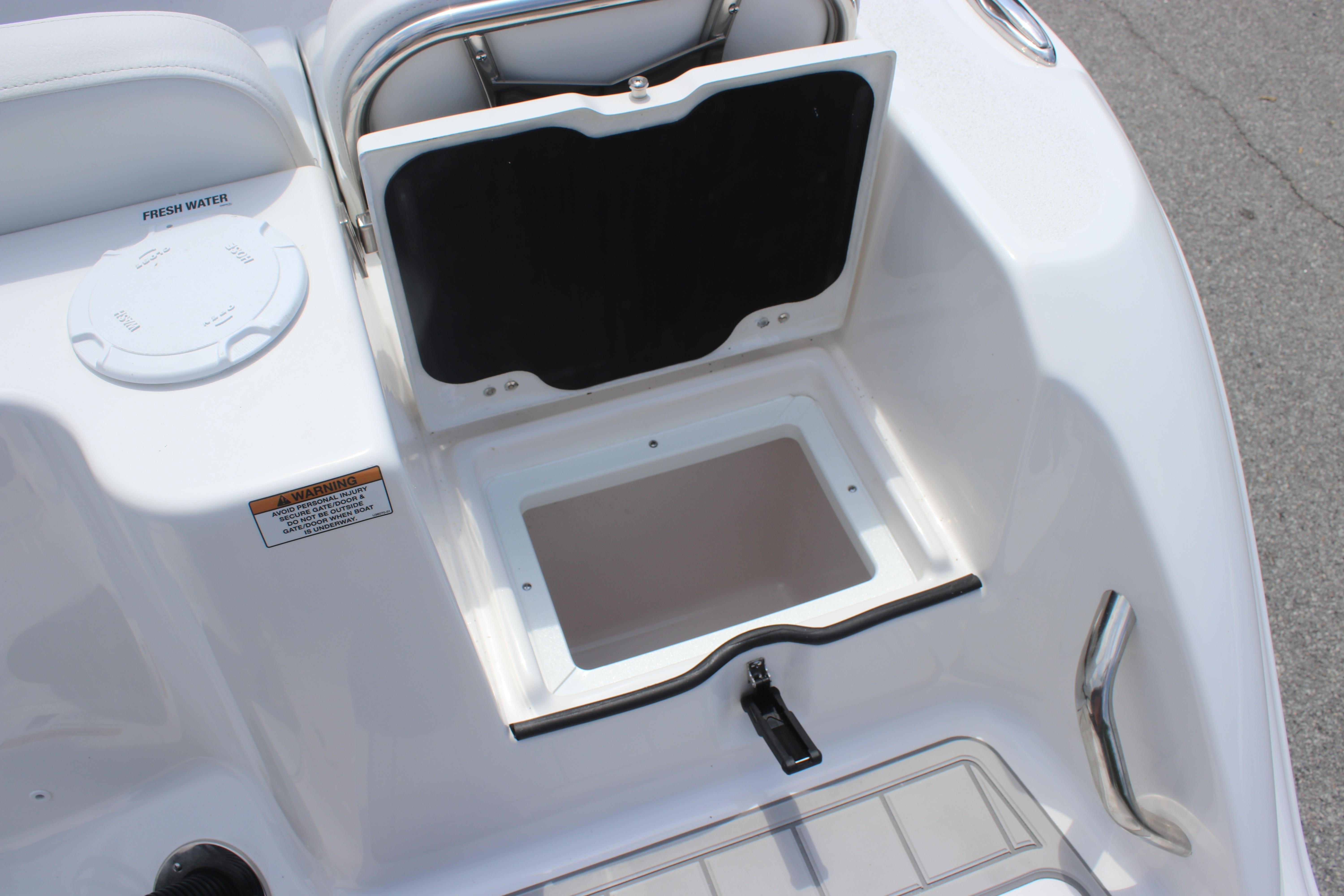 2026 Sea Fox 248 Commander boat storage compartment with fresh water access.
