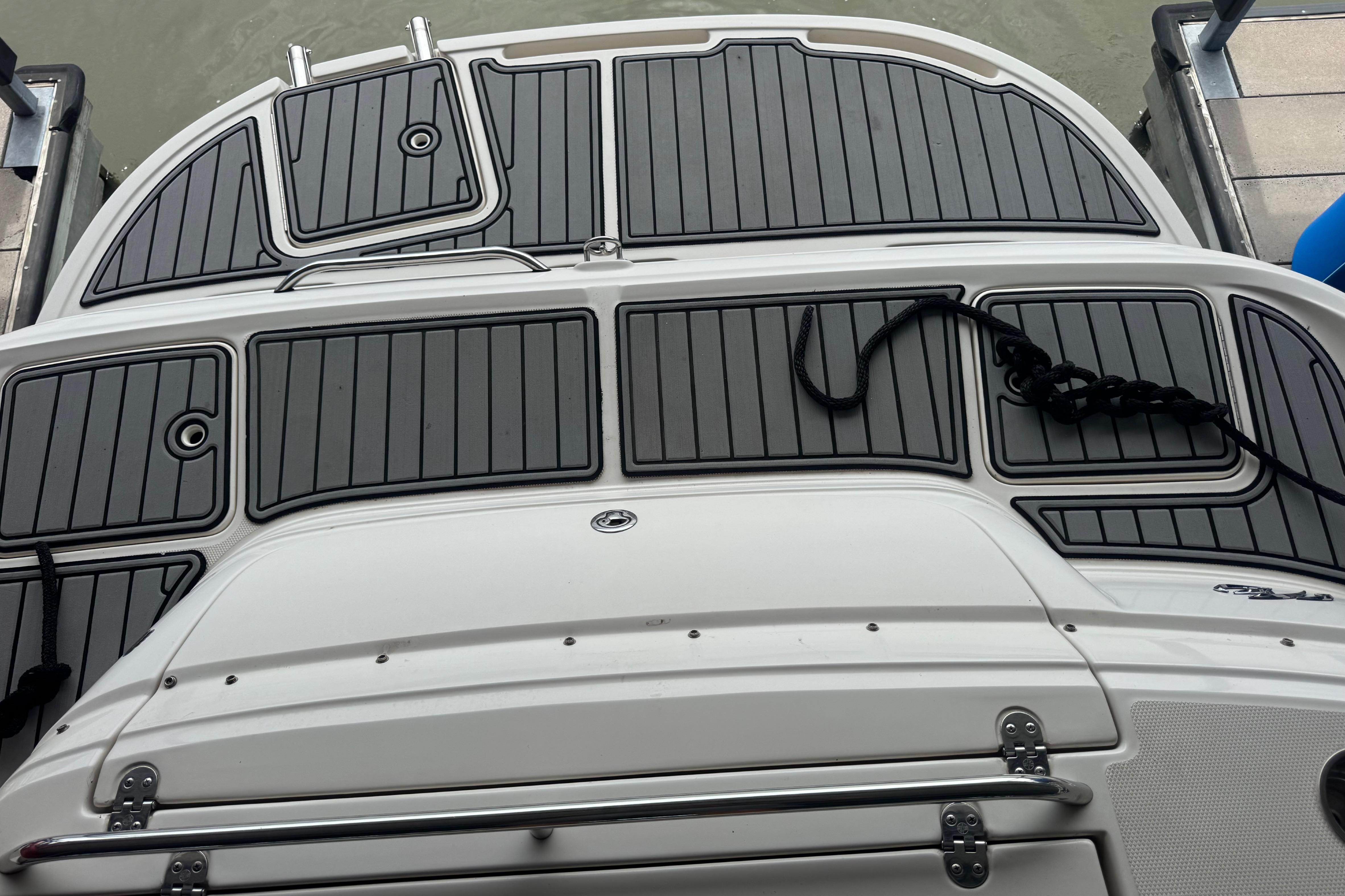 2005 Monterey 248LS Montura Bowrider swim platform with black non-slip decking.