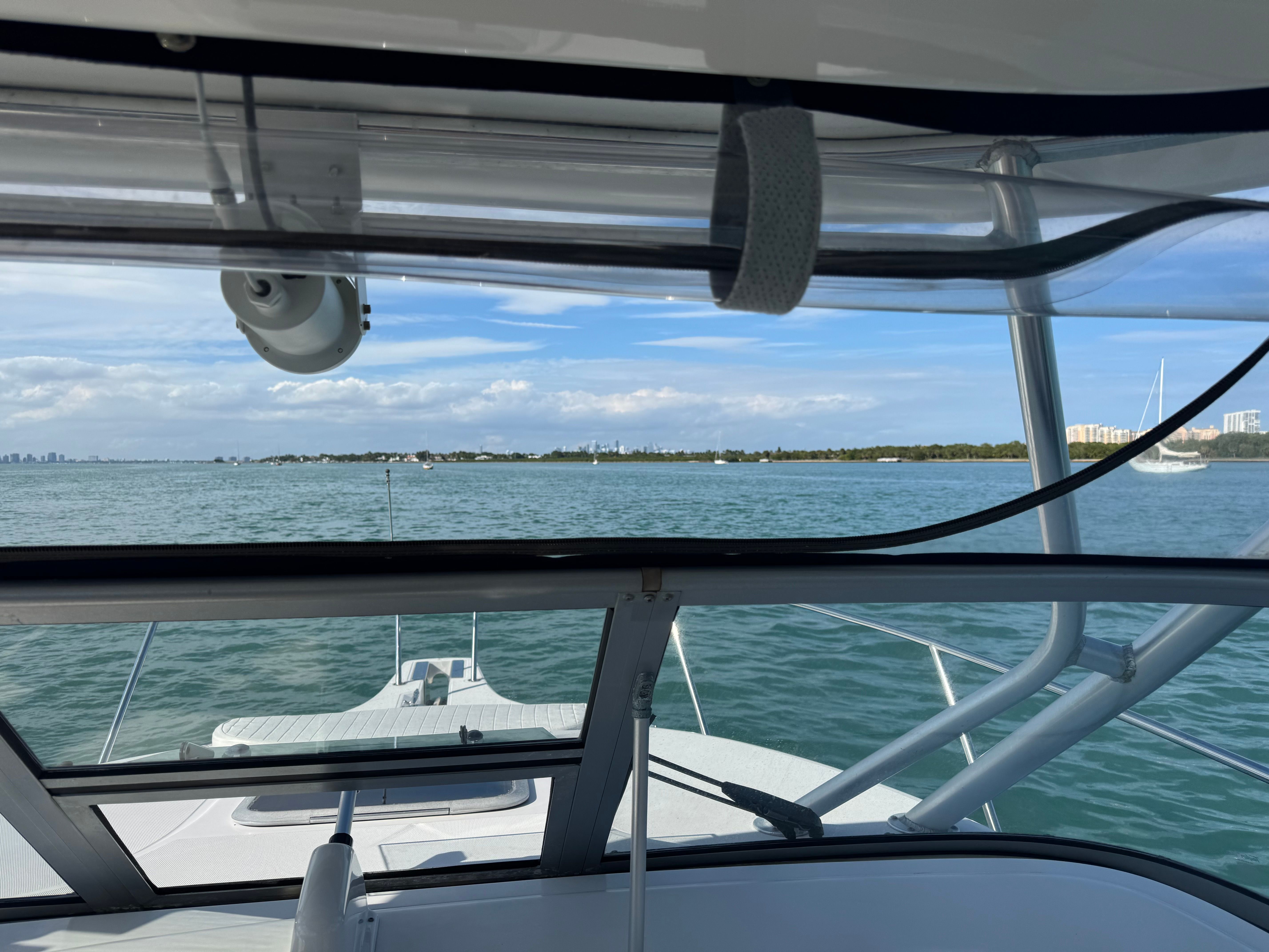 Boston Whaler 305 Conquest 2005 on calm waters with city view.