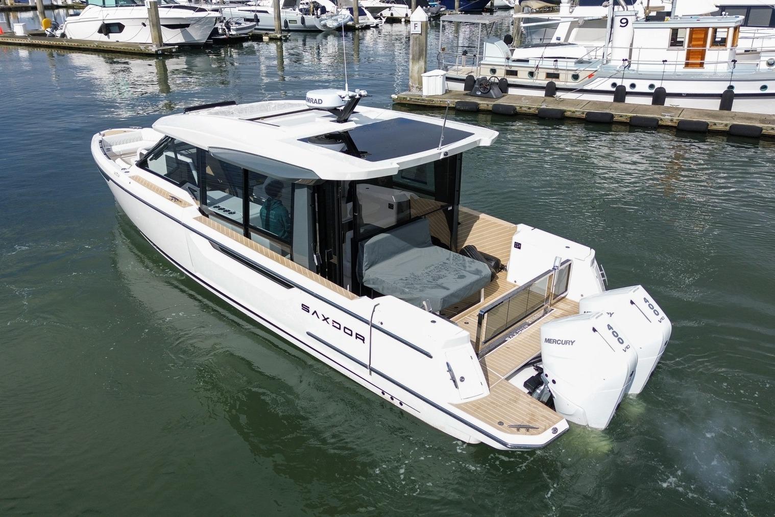2026 Saxdor 400 GTC luxury boat docked in marina, featuring sleek design and twin Mercury engines.