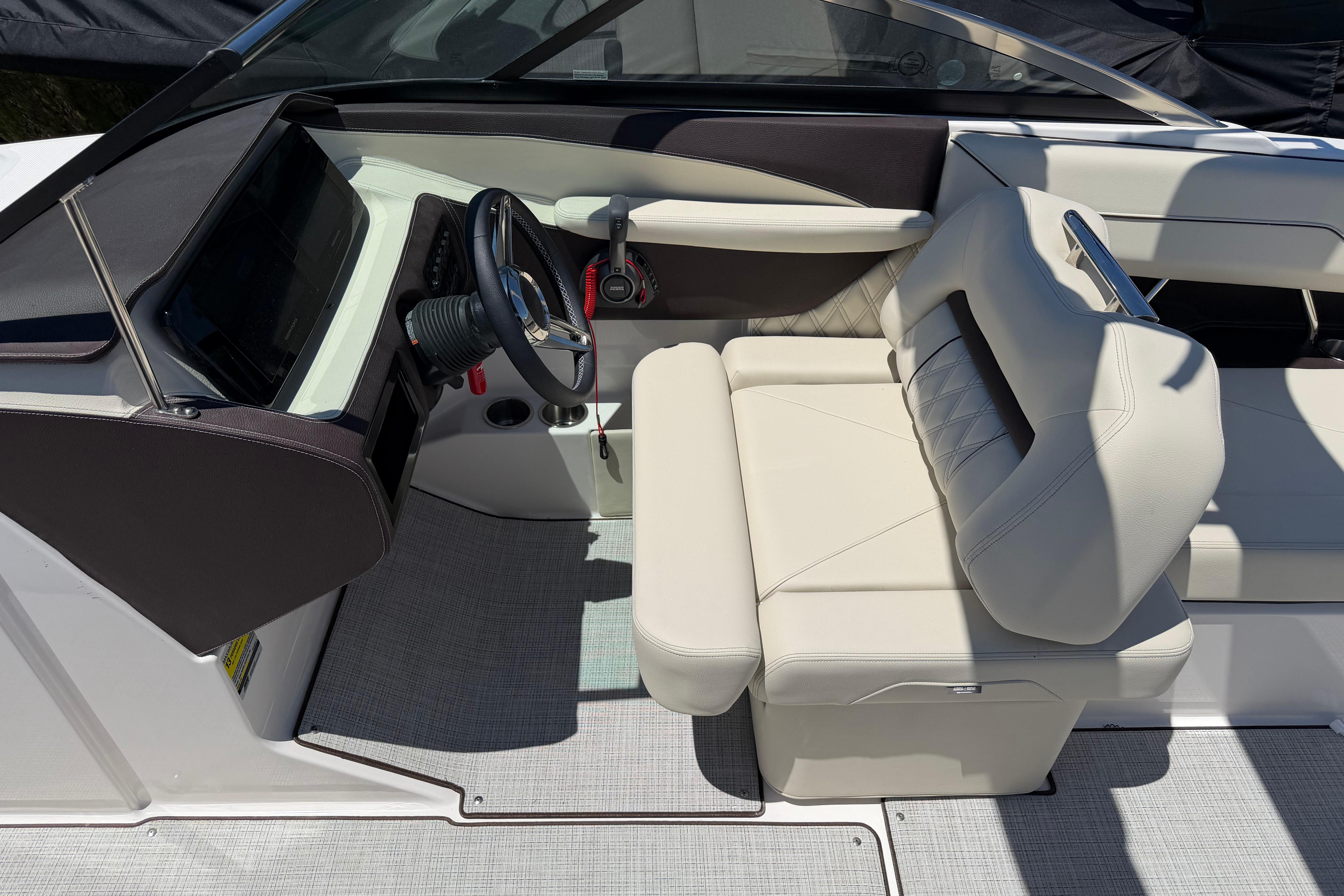 Luxurious interior of 2026 Regal LS4 boat with modern steering and plush seating.