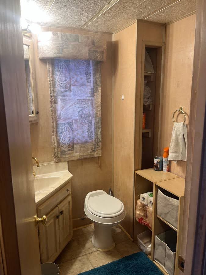 Bathroom in a 1993 Lakeview houseboat with toilet and sink.