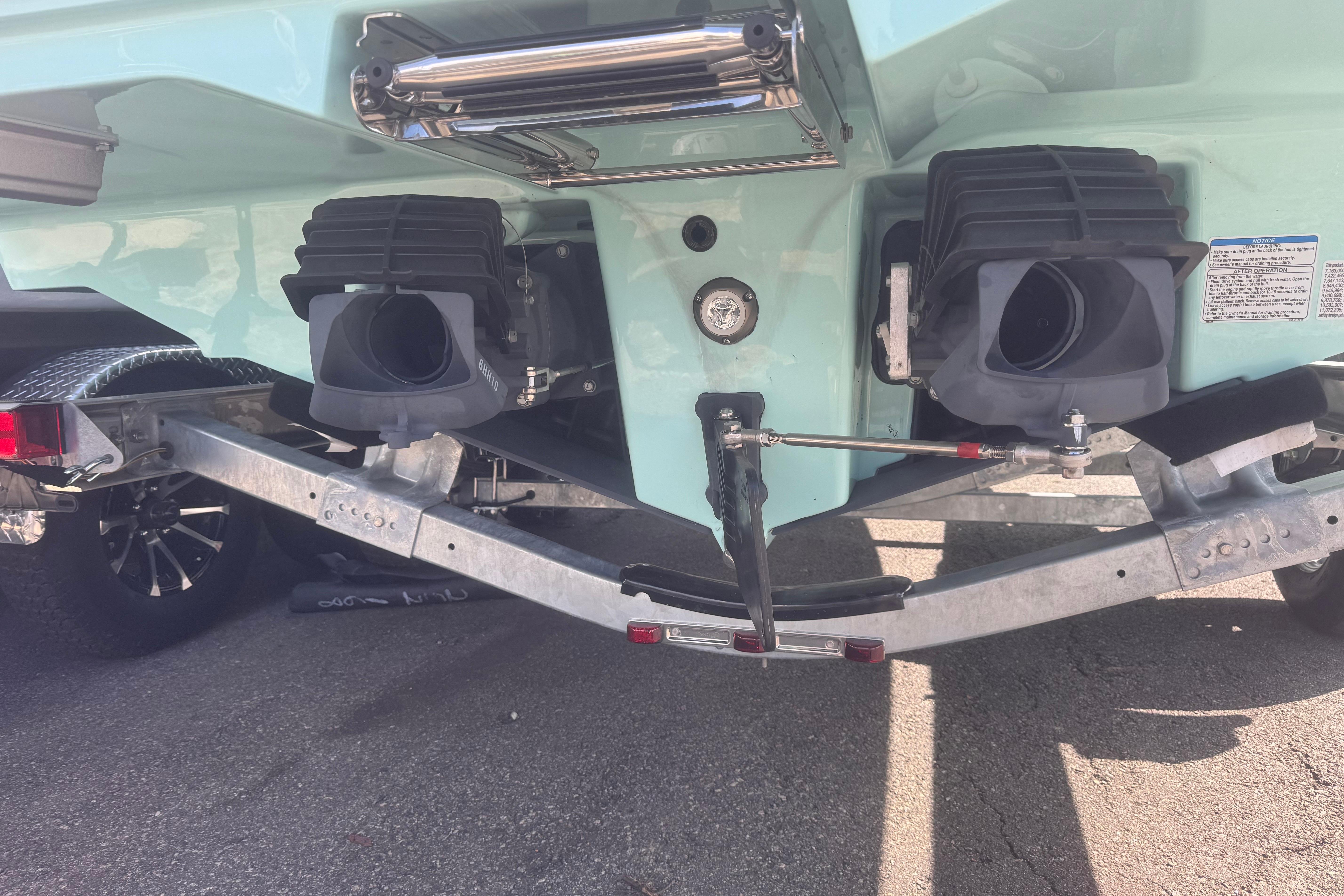 Rear view of 2026 Yamaha Boats 222 FSH Sport E on trailer, showcasing dual jet nozzles.