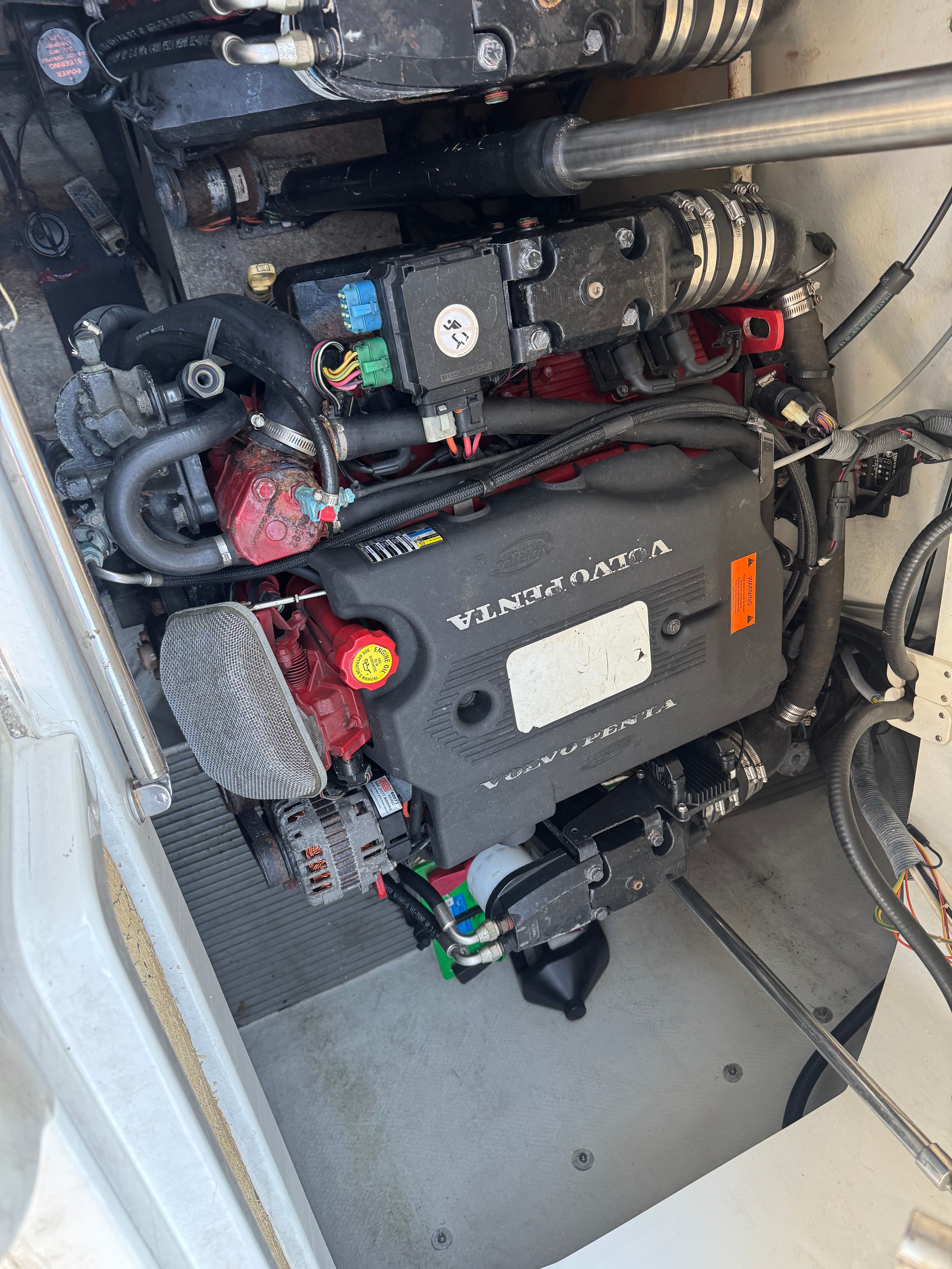 An engine compartment with a Volvo Penta engine in a 2003 Cobalt 360 boat.