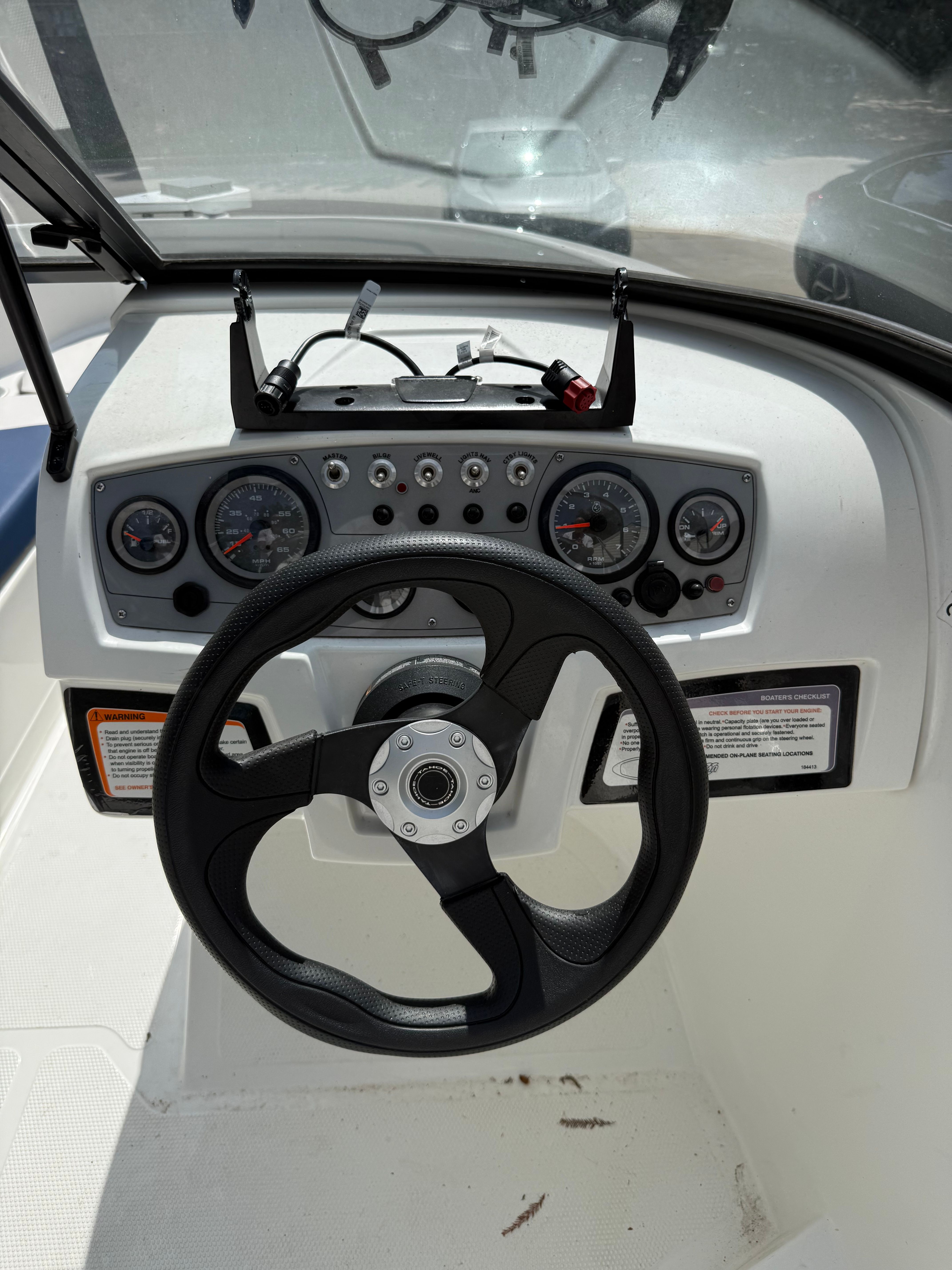 The image shows the helm of a 2019 Tahoe 450 TF boat with multiple gauges.