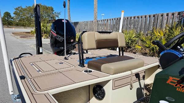 2025 Mako 18 Pro Skiff Backwater Edition boat with seating and motor, docked outdoors.