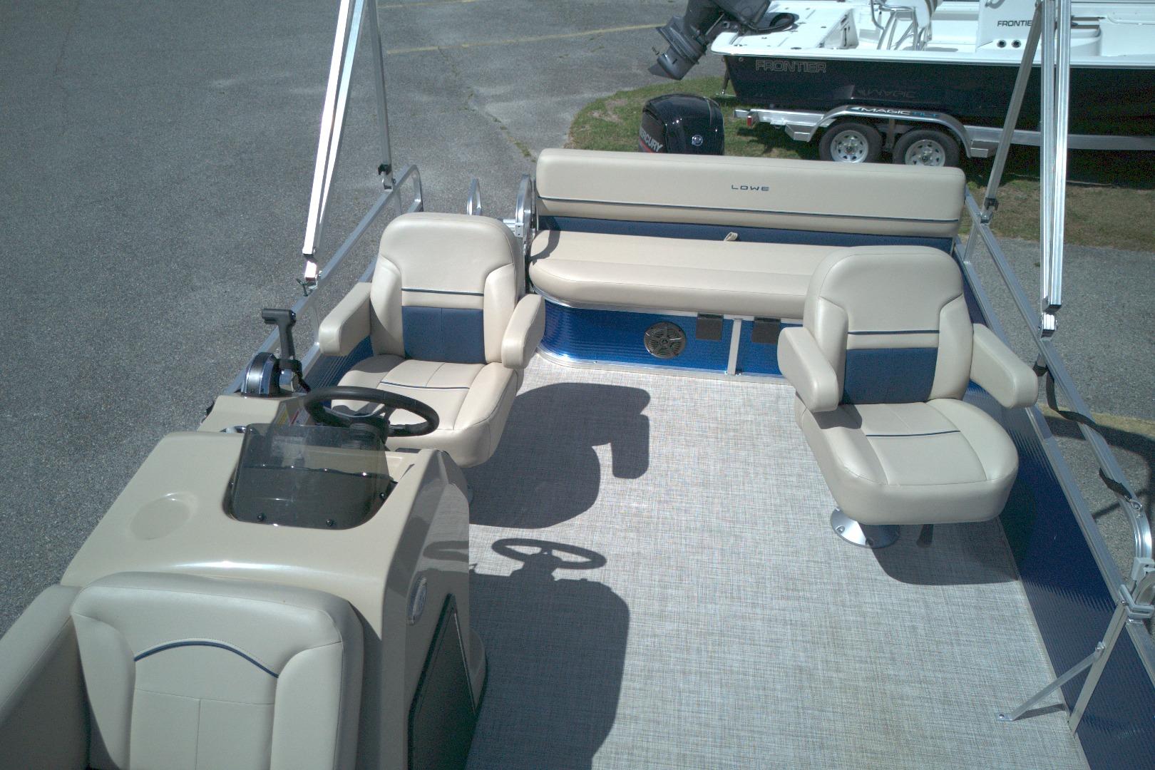 2024 Lowe Ultra 200 Cruise pontoon boat interior with beige seating and steering console.