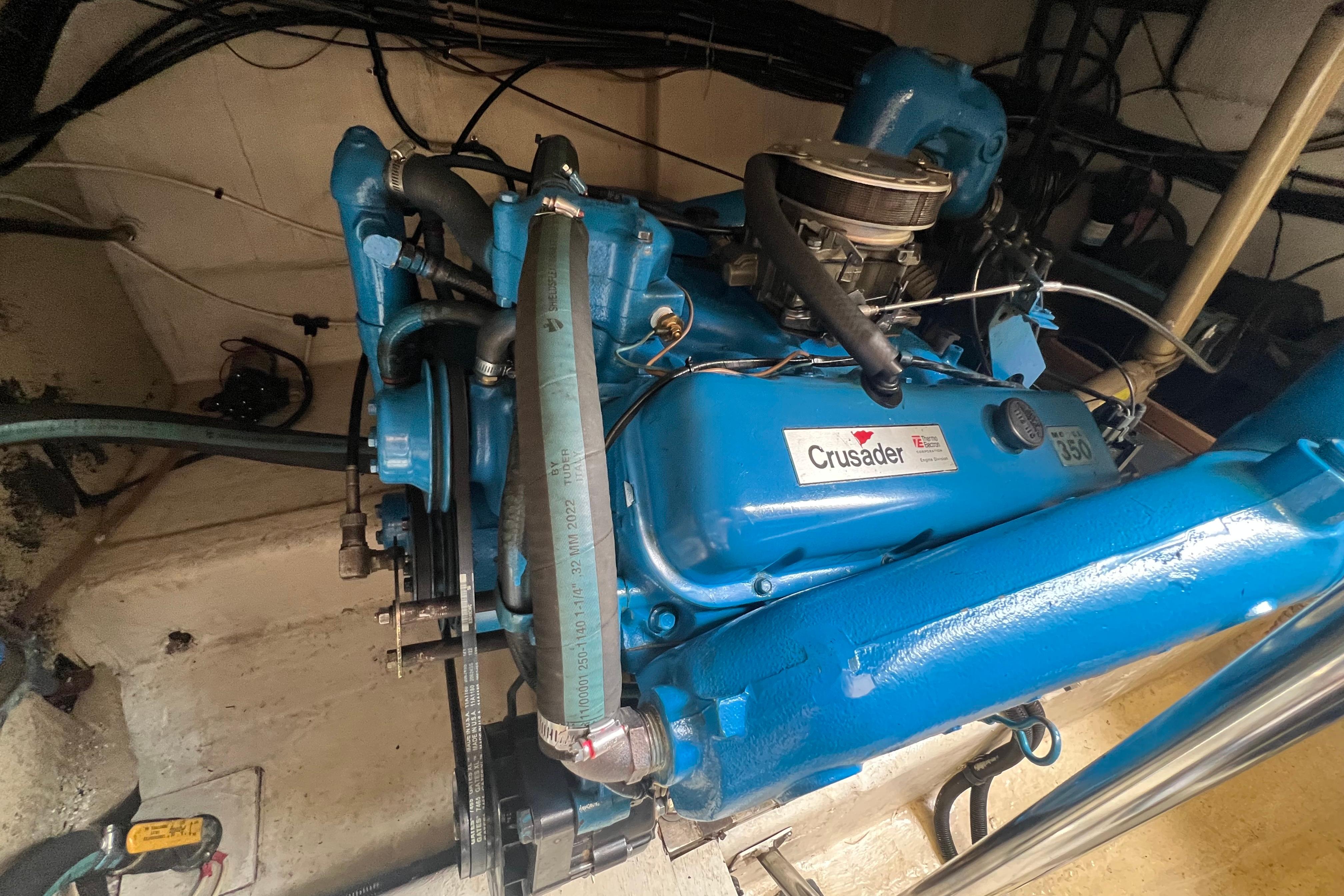 Engine of a 1985 Tiara 36 OPEN boat, featuring a blue Crusader 350 motor.