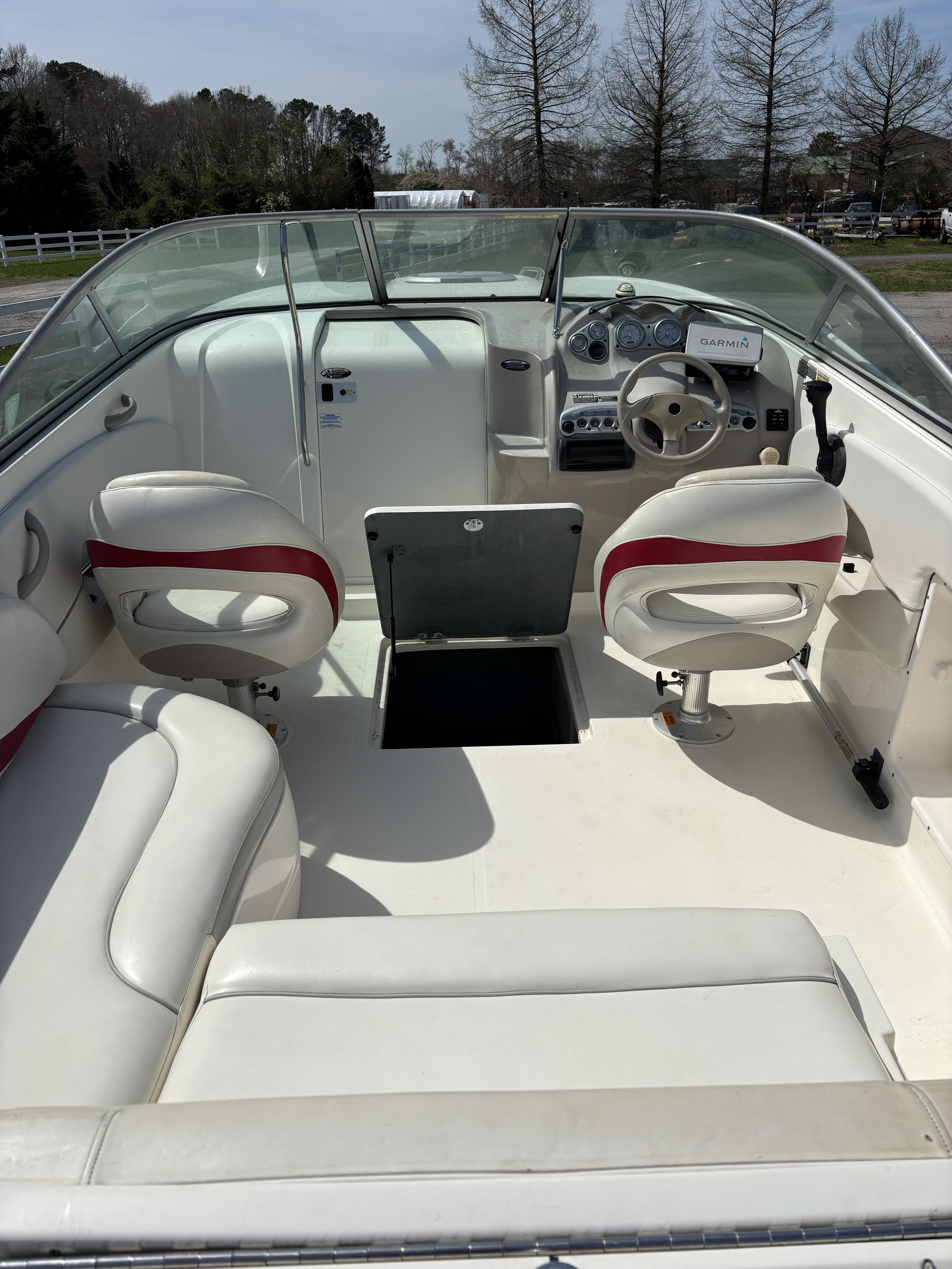 Interior of a 2005 Maxum 2400 SC3 boat with white seating.