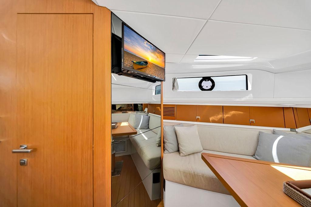 Luxurious interior of 2021 Bluegame BG 42 yacht with modern seating and TV.