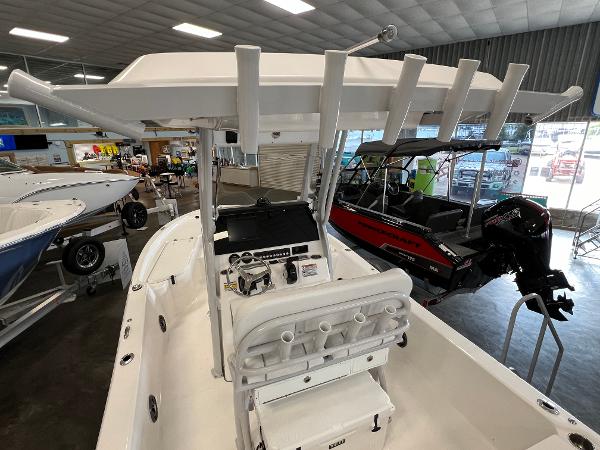 2024 Sea Fox 231 Bay boat interior with rod holders and console in showroom.