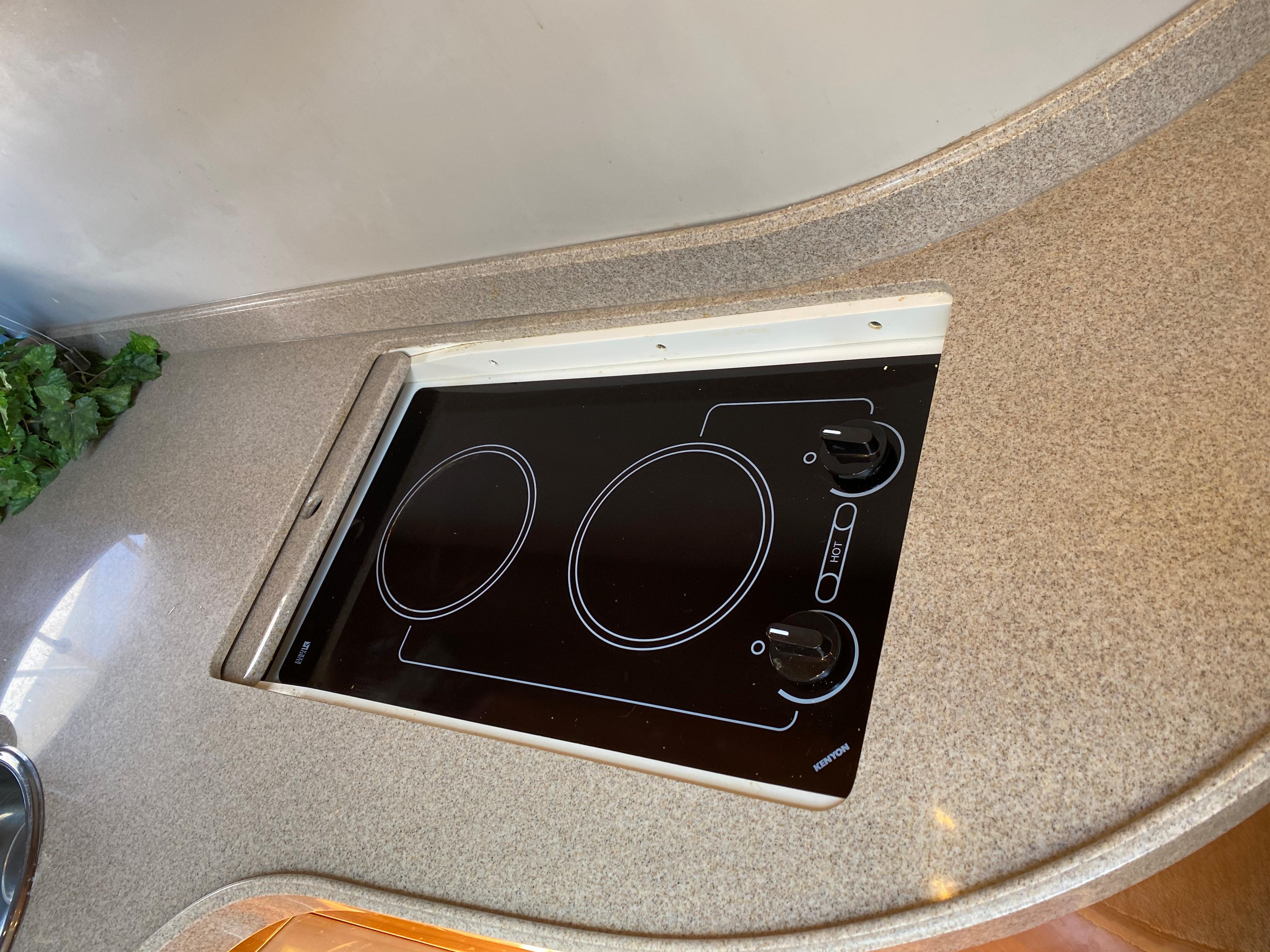 2002 Regal 3860 Commodore kitchen with built-in electric stovetop.