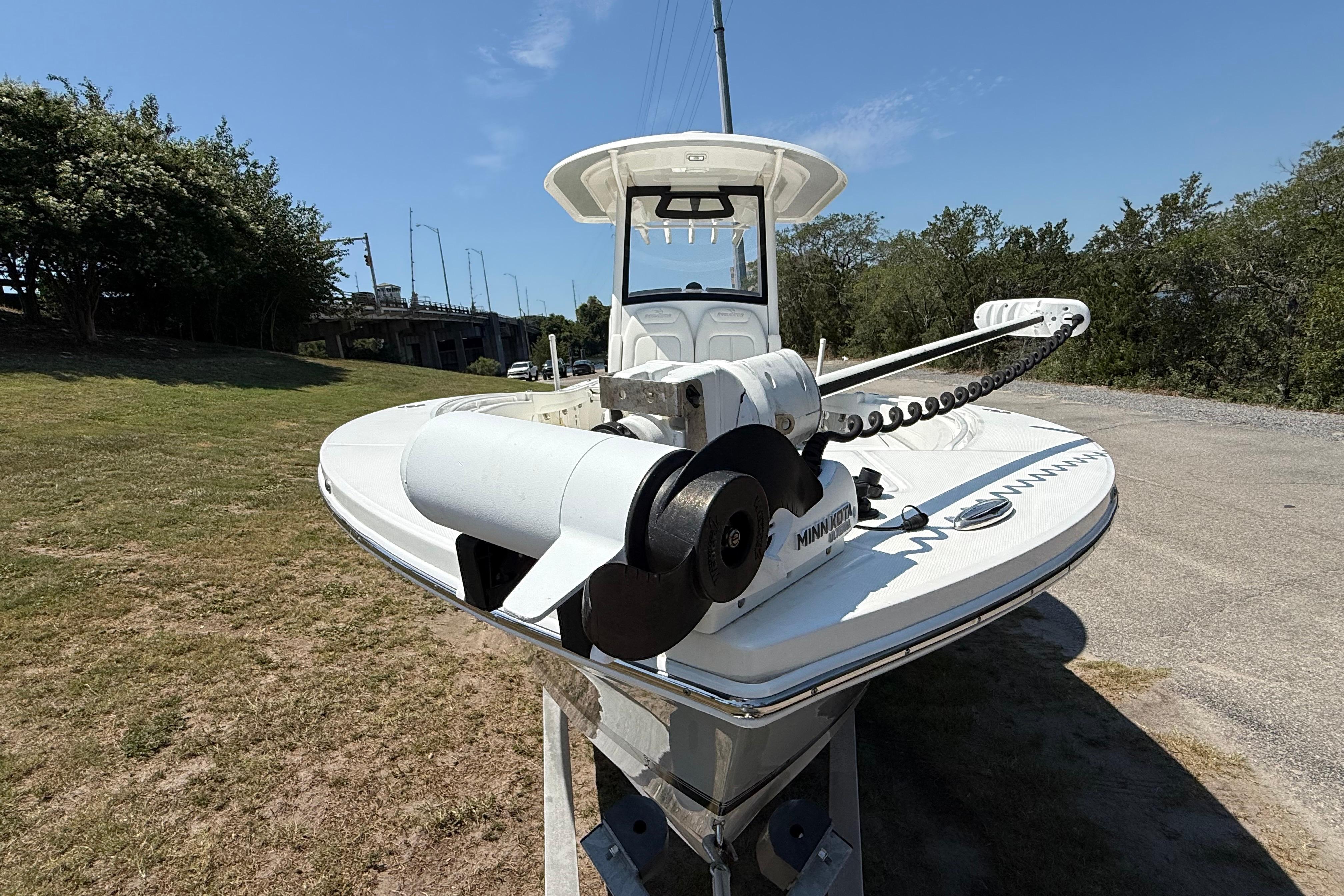2023 Regulator 26XO boat with Minn Kota trolling motor on a sunny day.