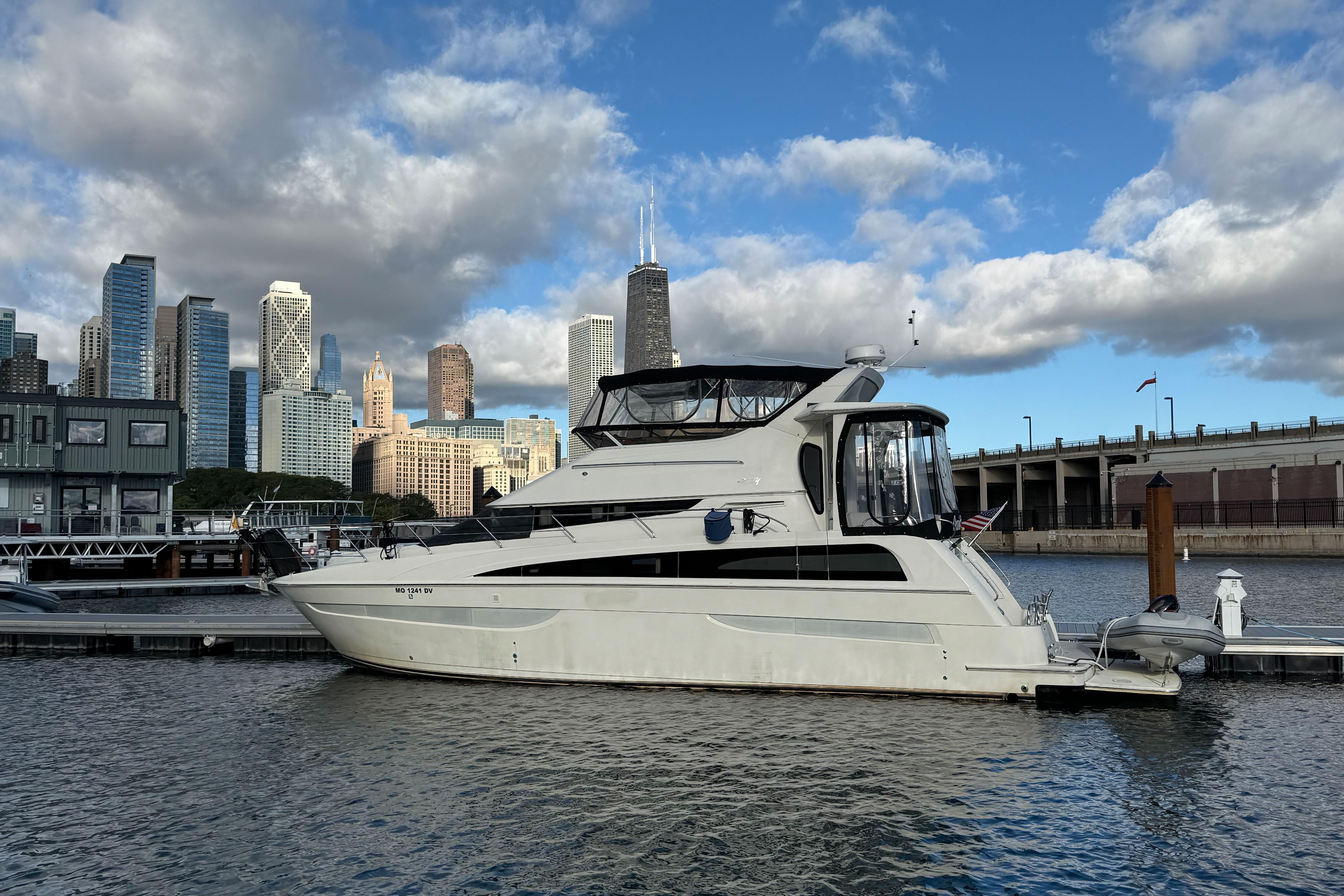 2006 Carver 43 Motor Yacht docked with city skyline in the background.