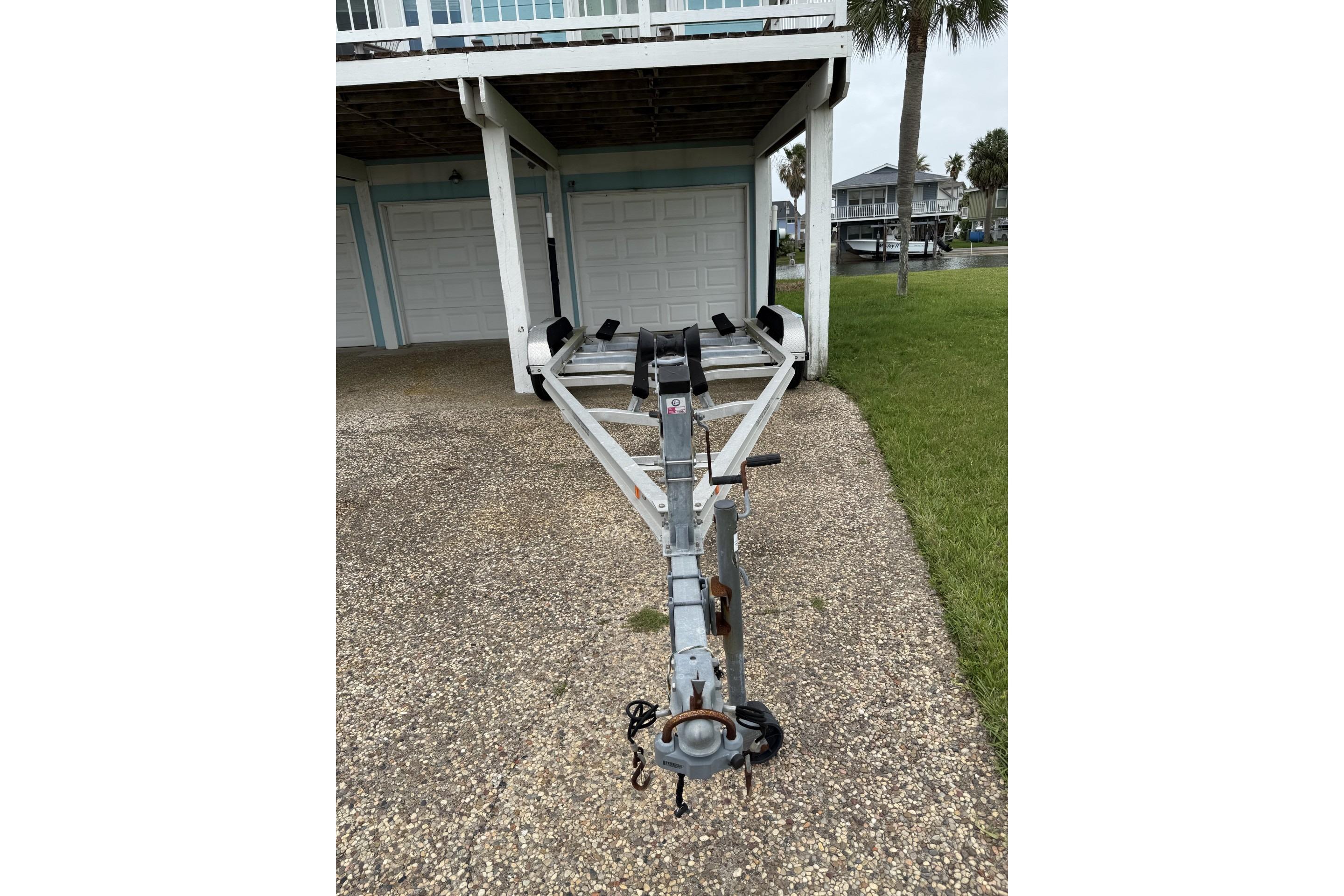 Boat trailer parked on driveway, suitable for 2017 Blue Wave 2200 PureBay.