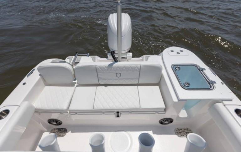 2026 Sea Fox 228 Commander boat interior with white seating and storage compartments.