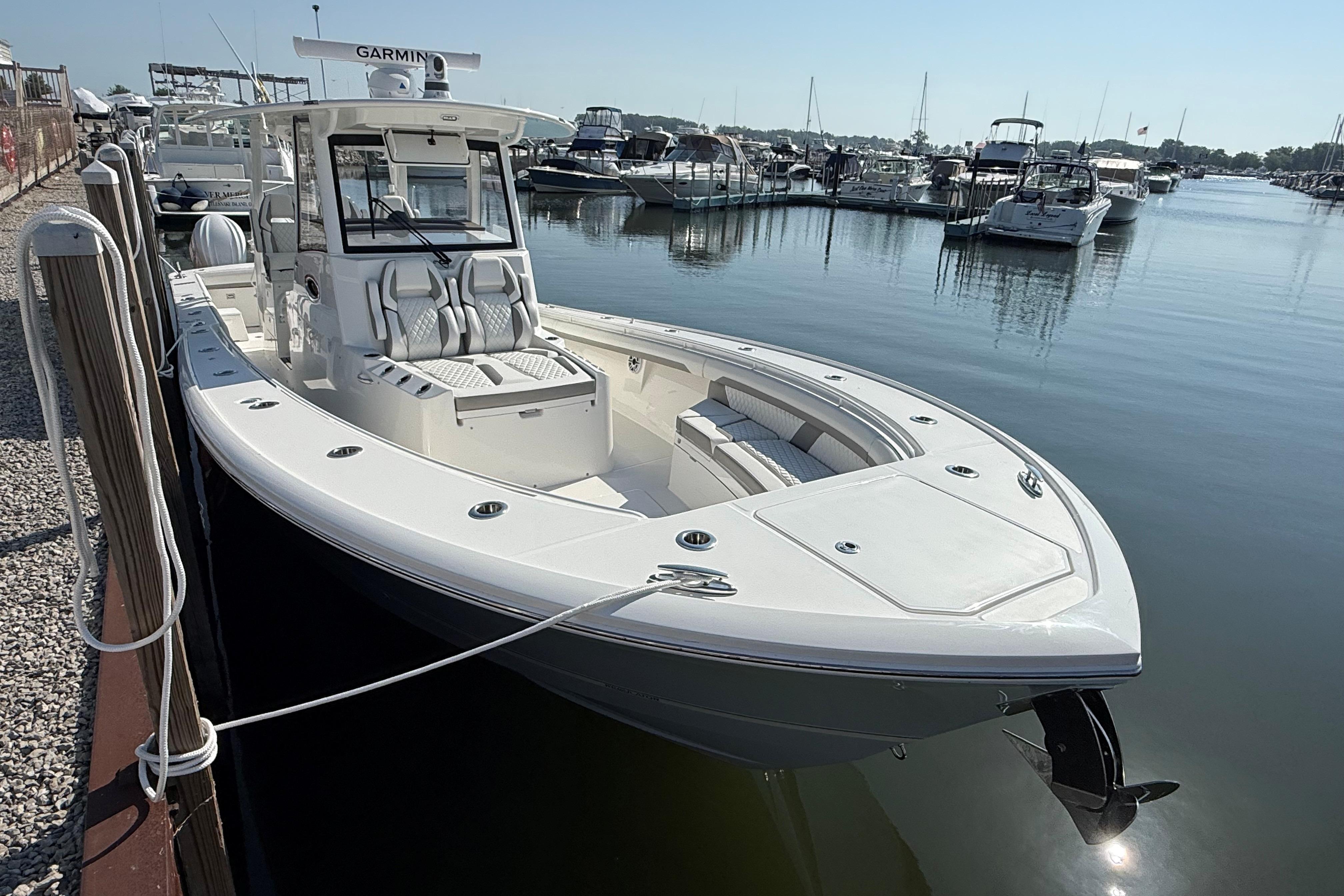 2026 Regulator 35 boat docked at marina, featuring sleek design and spacious seating.