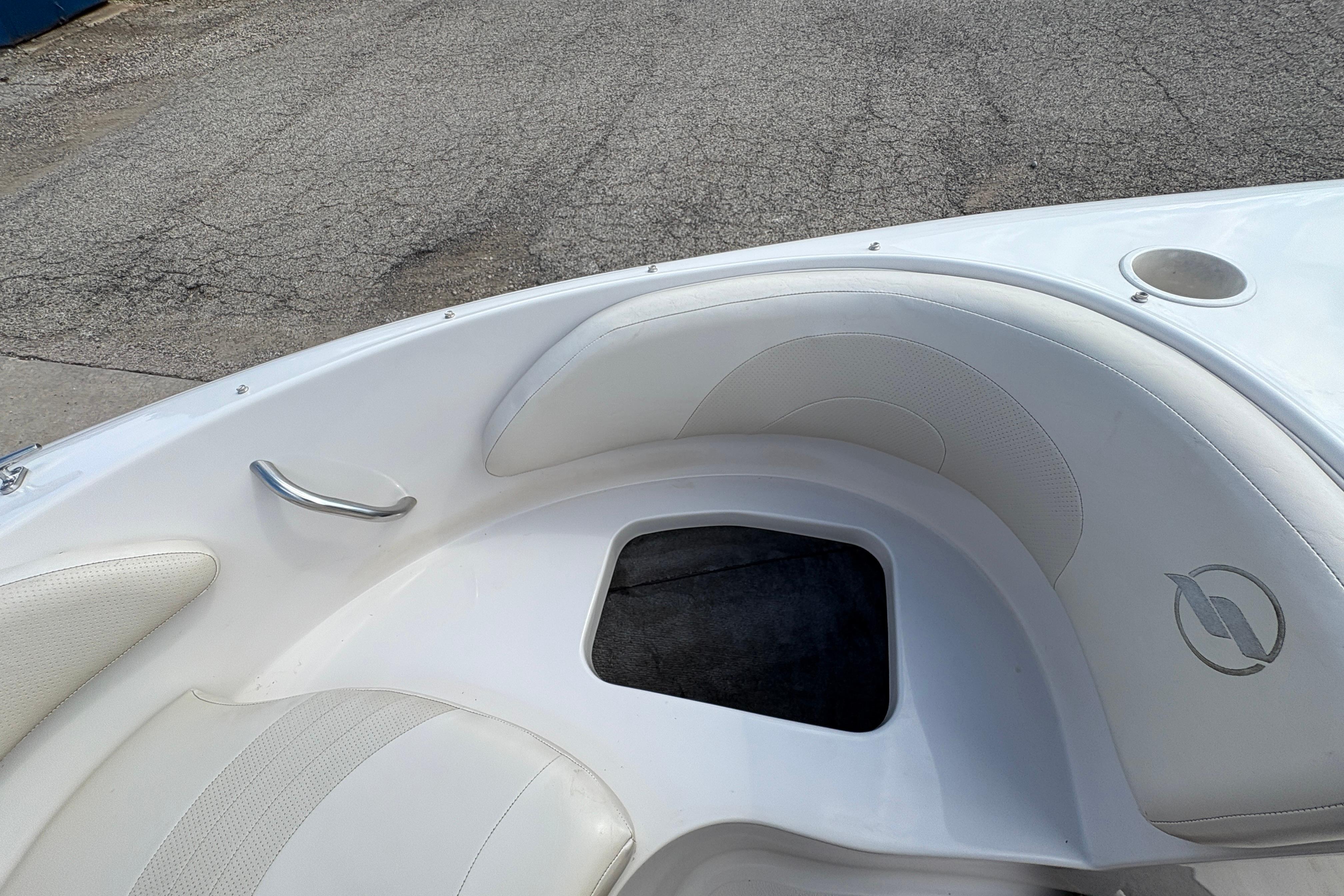 2005 Starcraft C-Star 1700 OB boat interior with white seating and storage compartment.