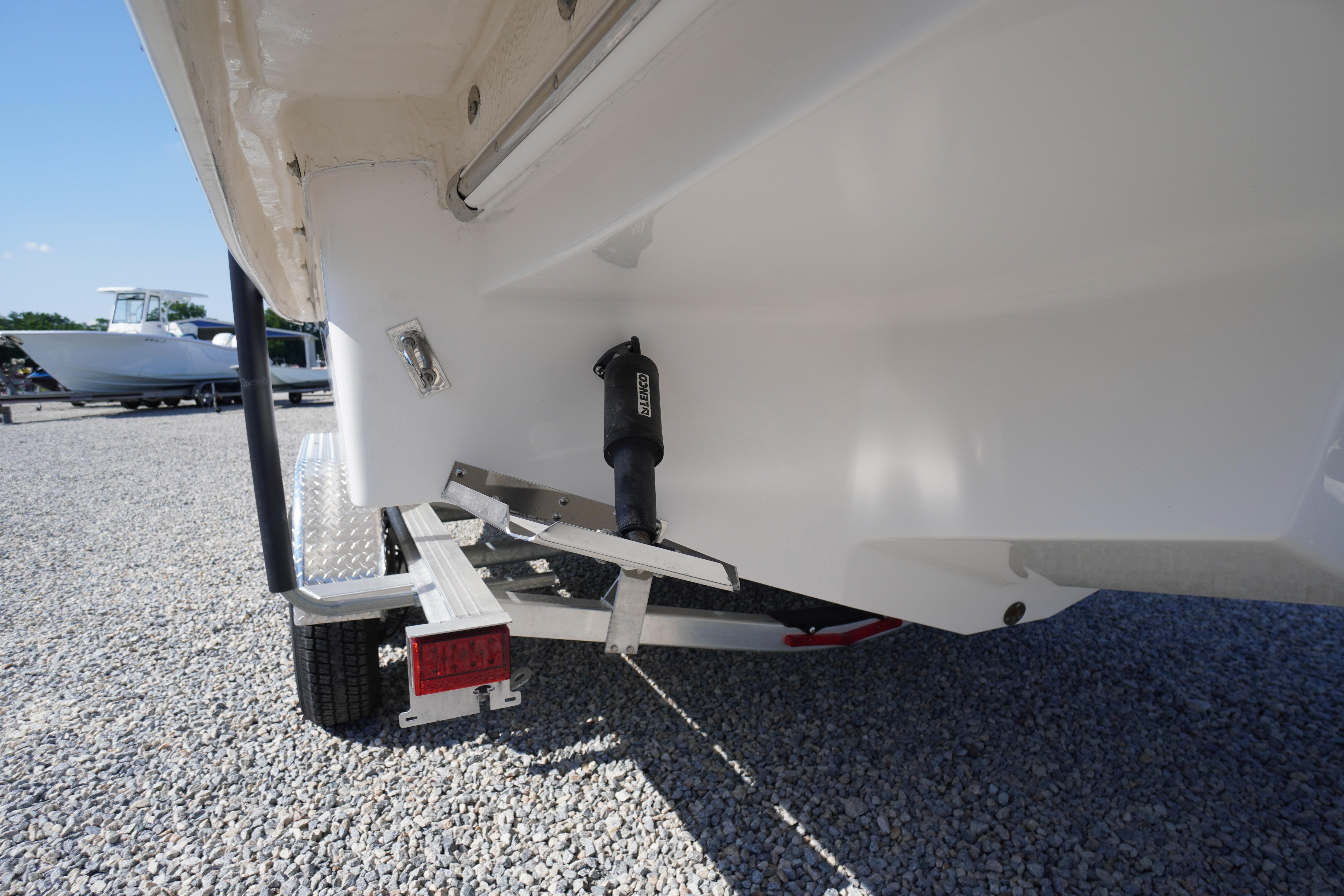 2026 Chaparral 270 OSX boat on trailer, rear view showing hull and trim tab.